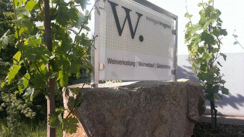 Wagner winery sign with vines in the background.