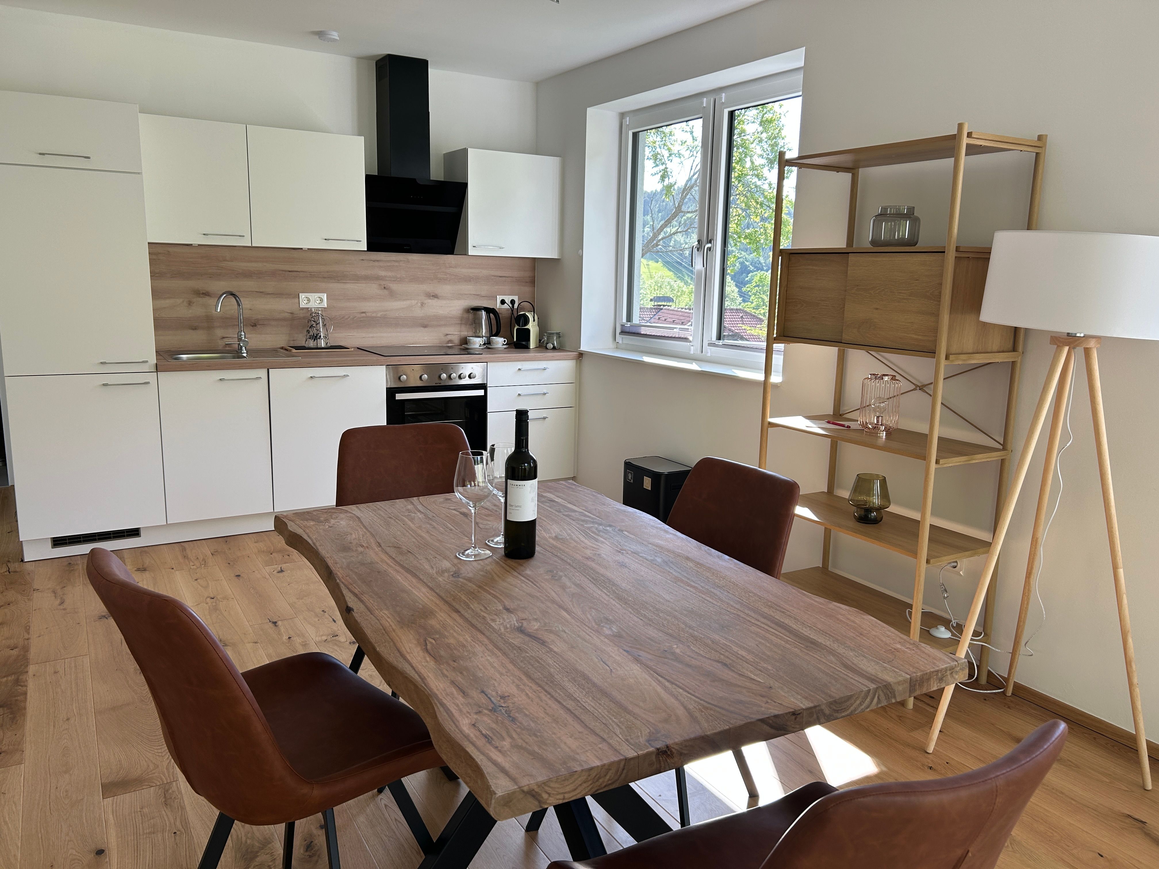 Interior view of a modern kitchen with dining table and chairs.