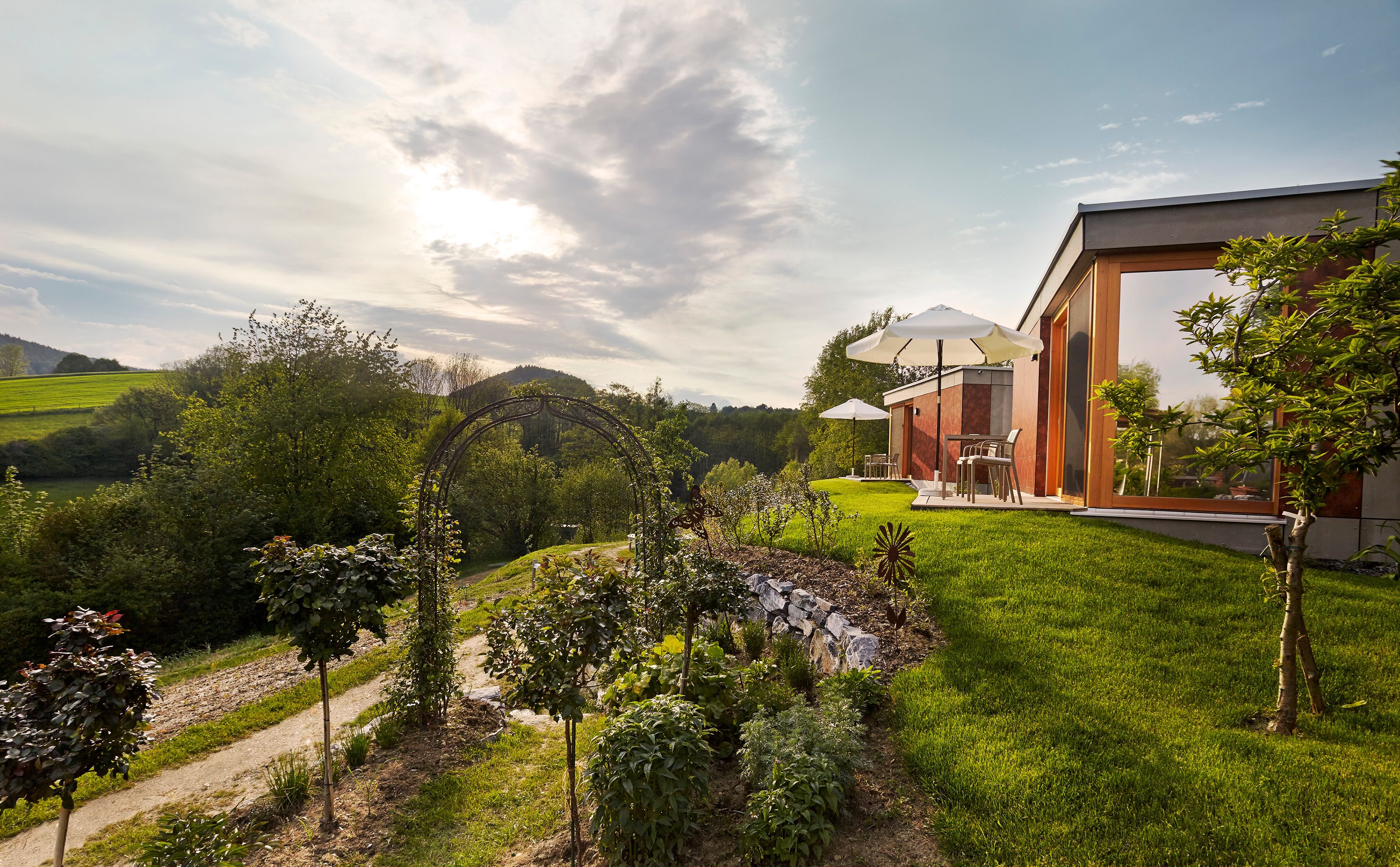 Modern accommodation in a green landscape with sunshades and garden.