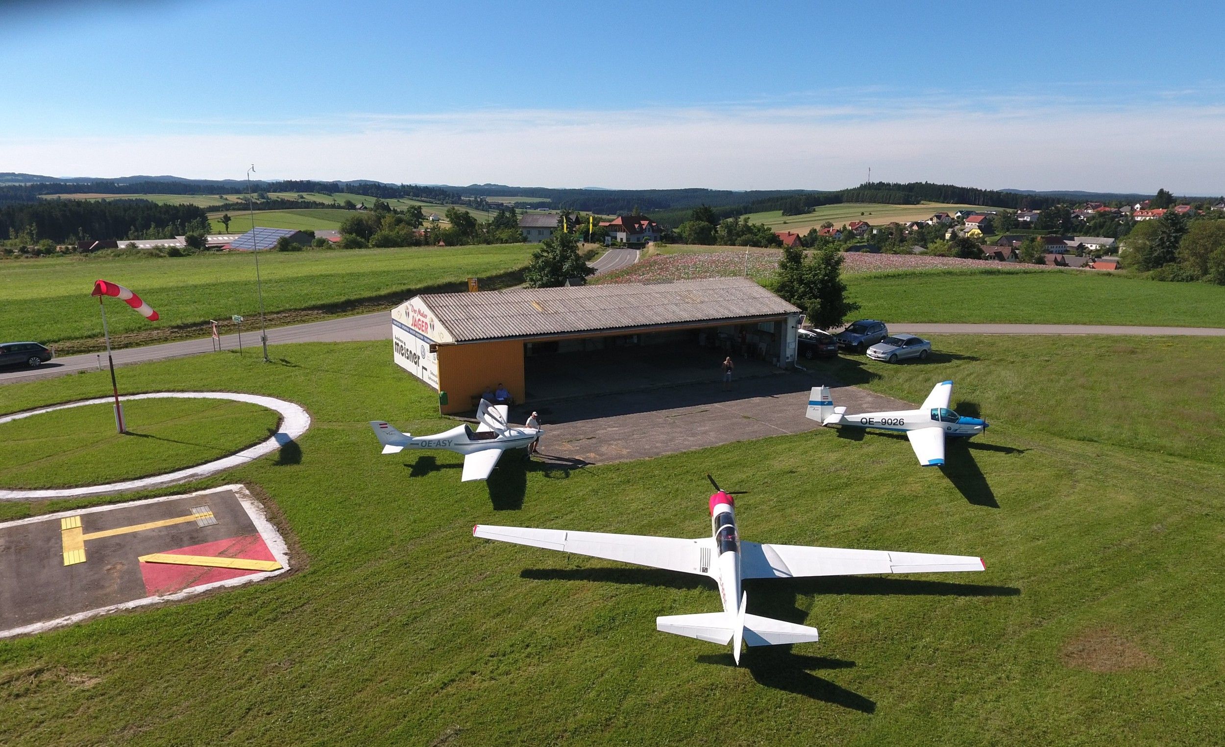 Landscape with airfield, gliders and windsock.