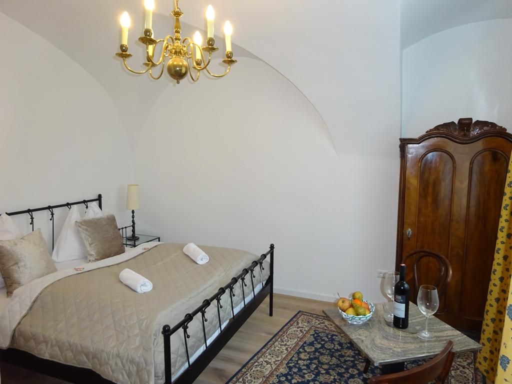 Room with double bed and chandelier, tastefully decorated 