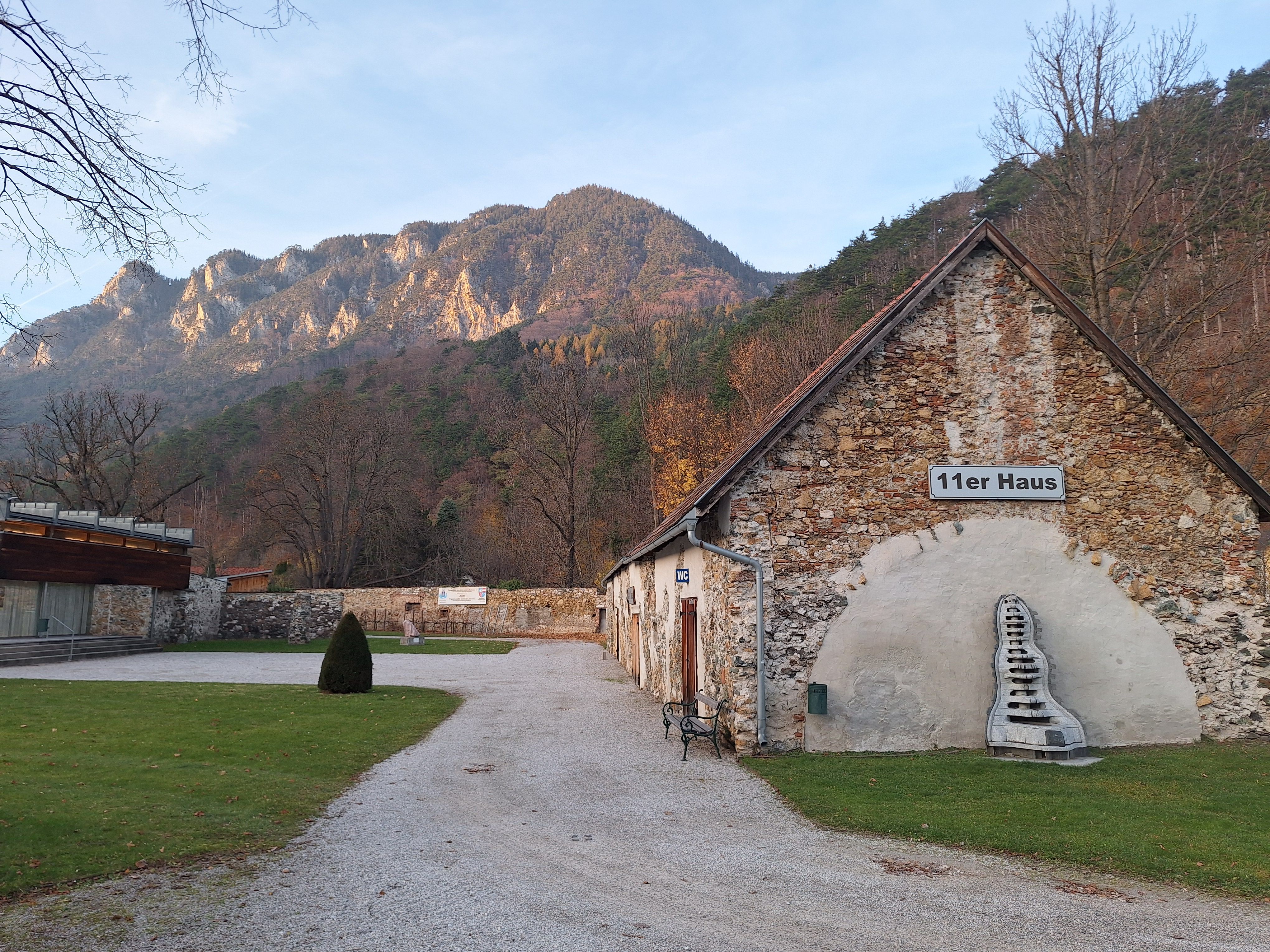 Exterior view of the 11er Haus with mountain scenery in the background.