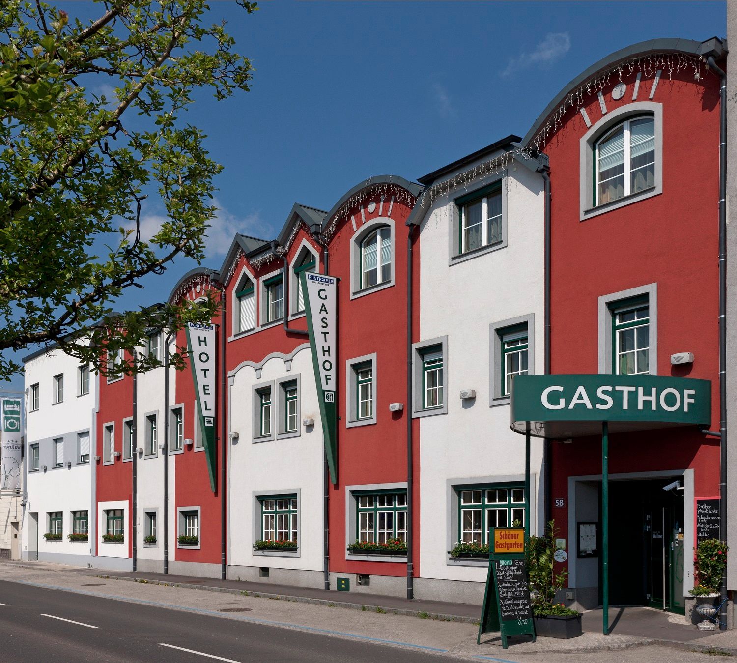 Exterior view of the Restaurant-Hotel Wallner with red and white façade.
