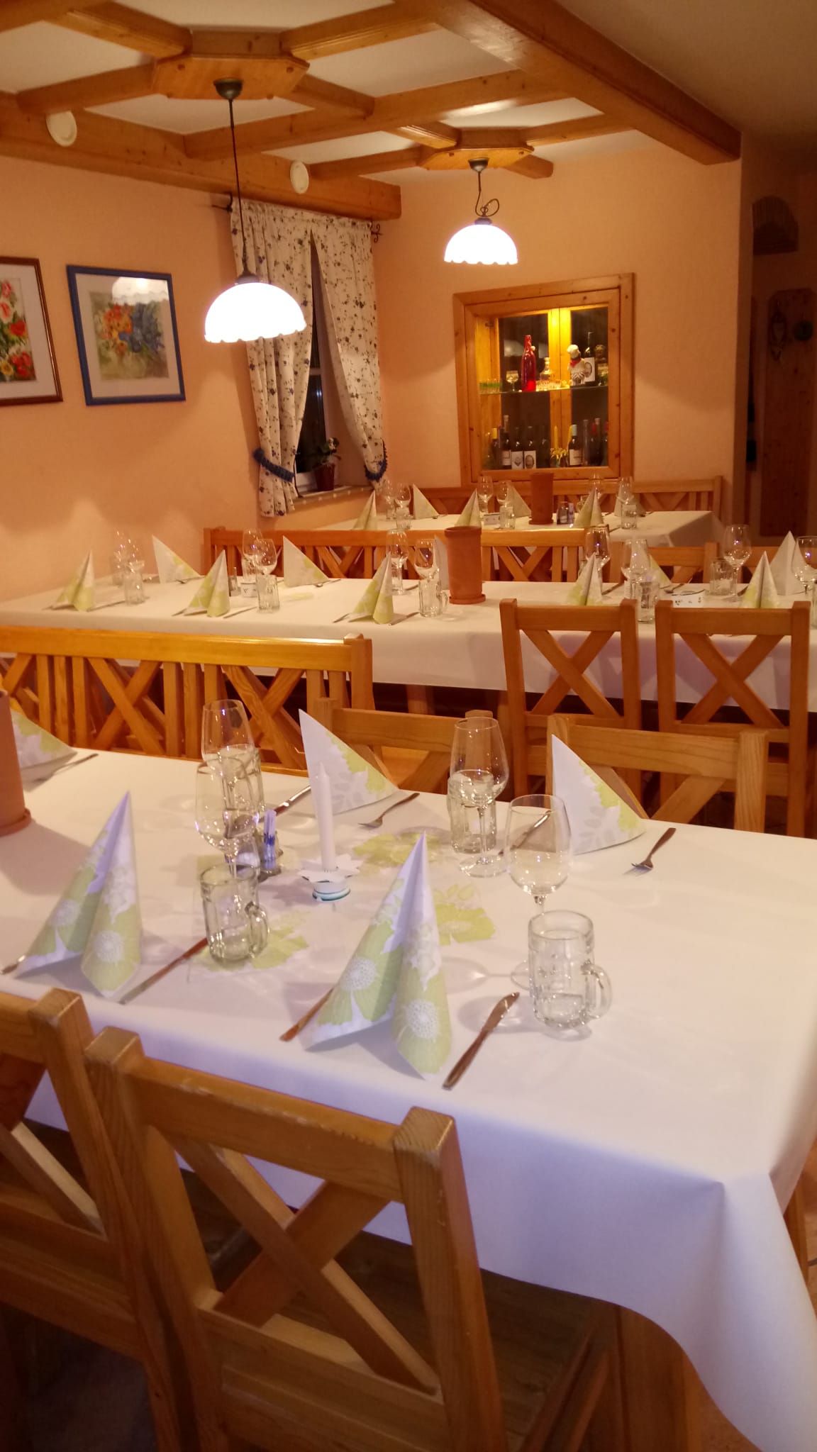 Tables set inside with white table linen 
