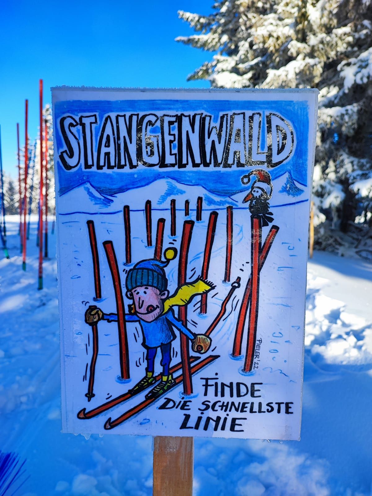 Sign in the snow with cartoon character on skis and text 'Stangenwald, find the fastest line'.