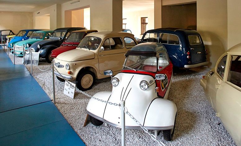 A collection of classic cars in an automobile museum.