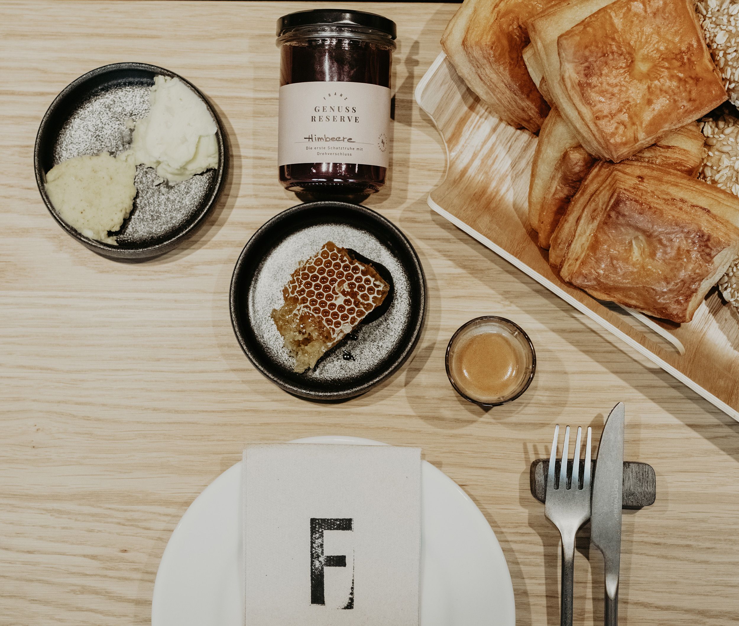 Breakfast pastries, honey, place setting