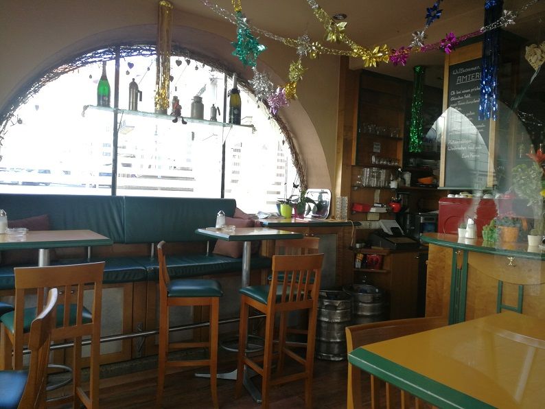 Interior view of a cozy café with decorations and seating.