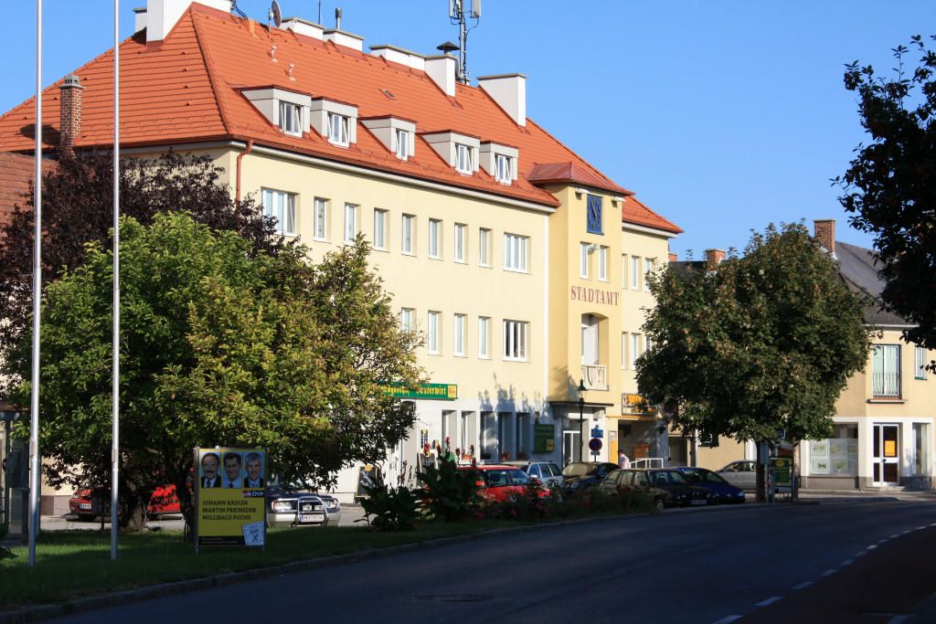 Ebenfurth town hall with surrounding buildings and trees.