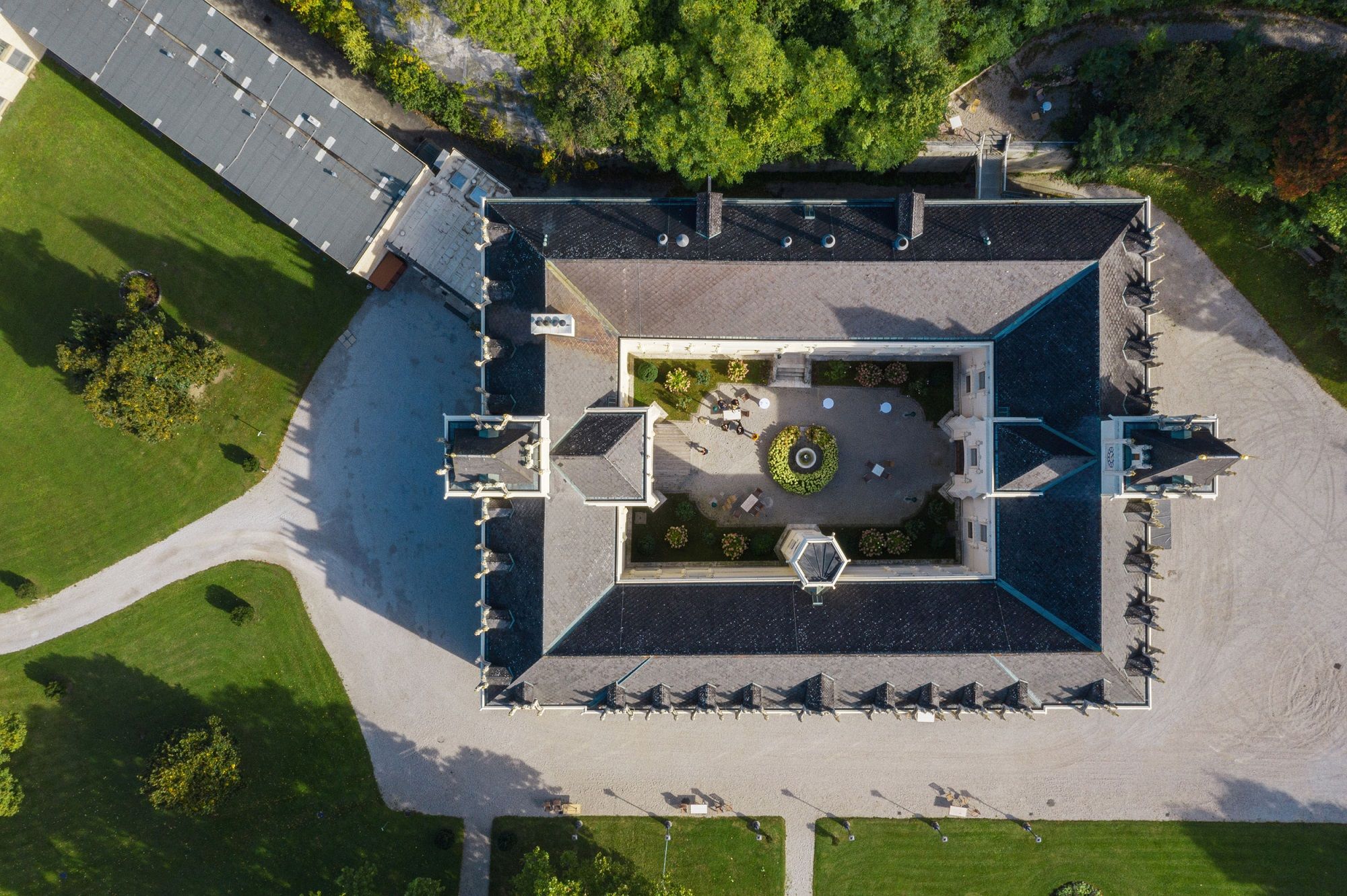 Aerial view of Schloss Hernstein with inner courtyard and surrounding garden.