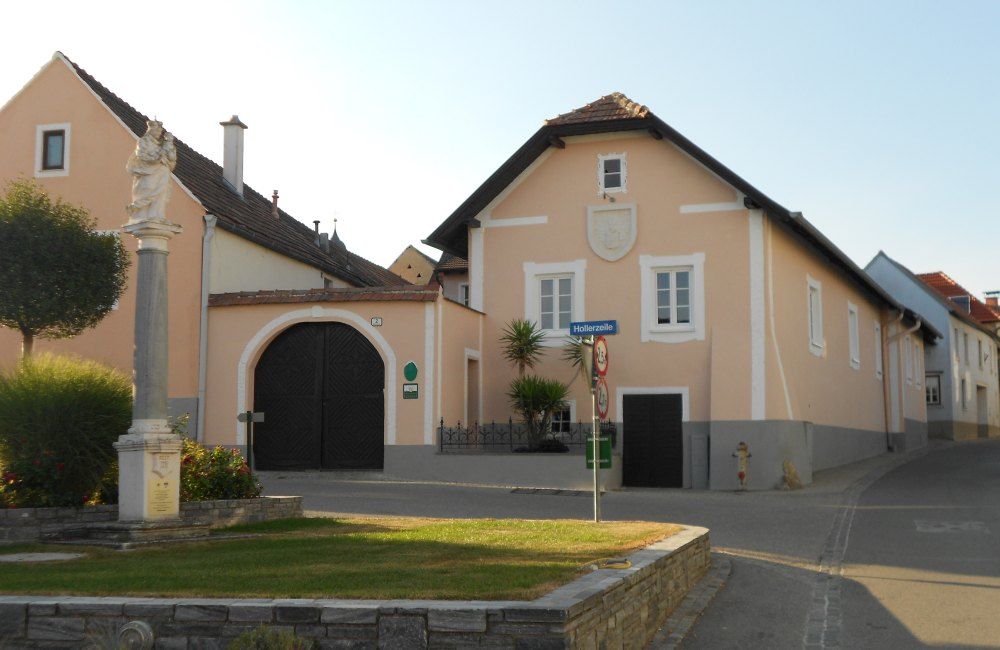 Traditional building with archway and statue in the foreground.