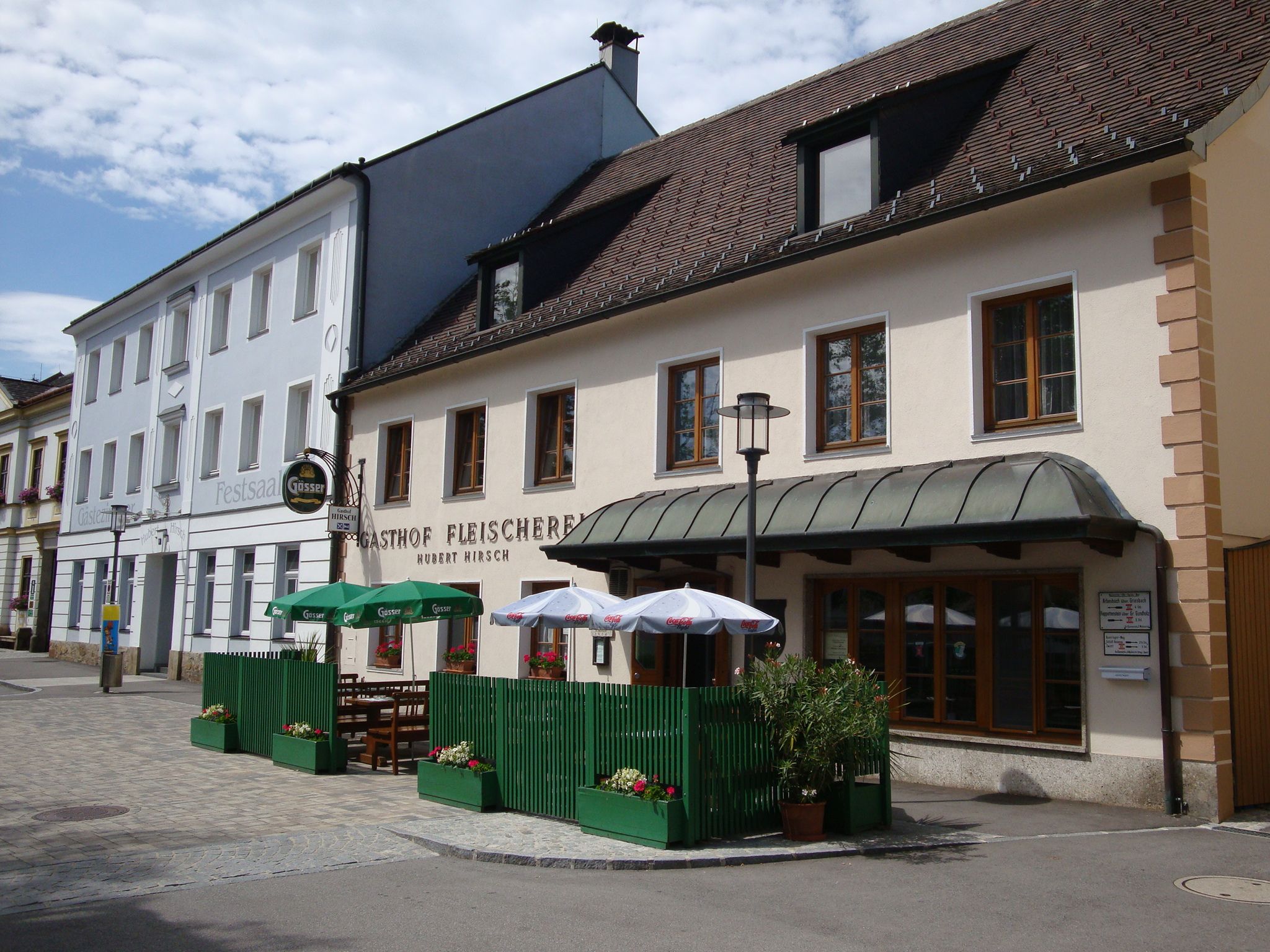 Hirsch butcher's restaurant with outdoor terrace and parasols.