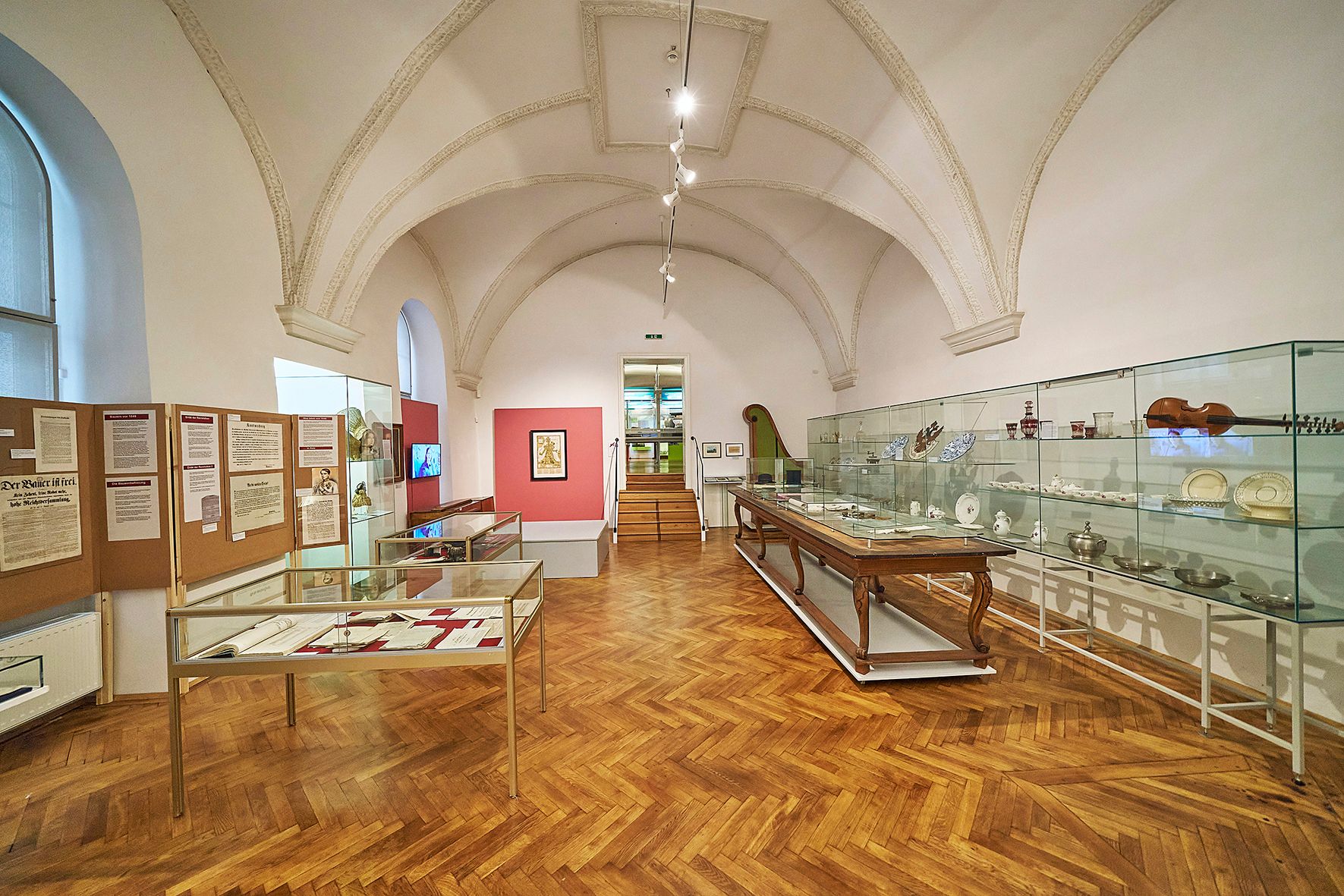 Interior view of a museum room with display cases and exhibits.