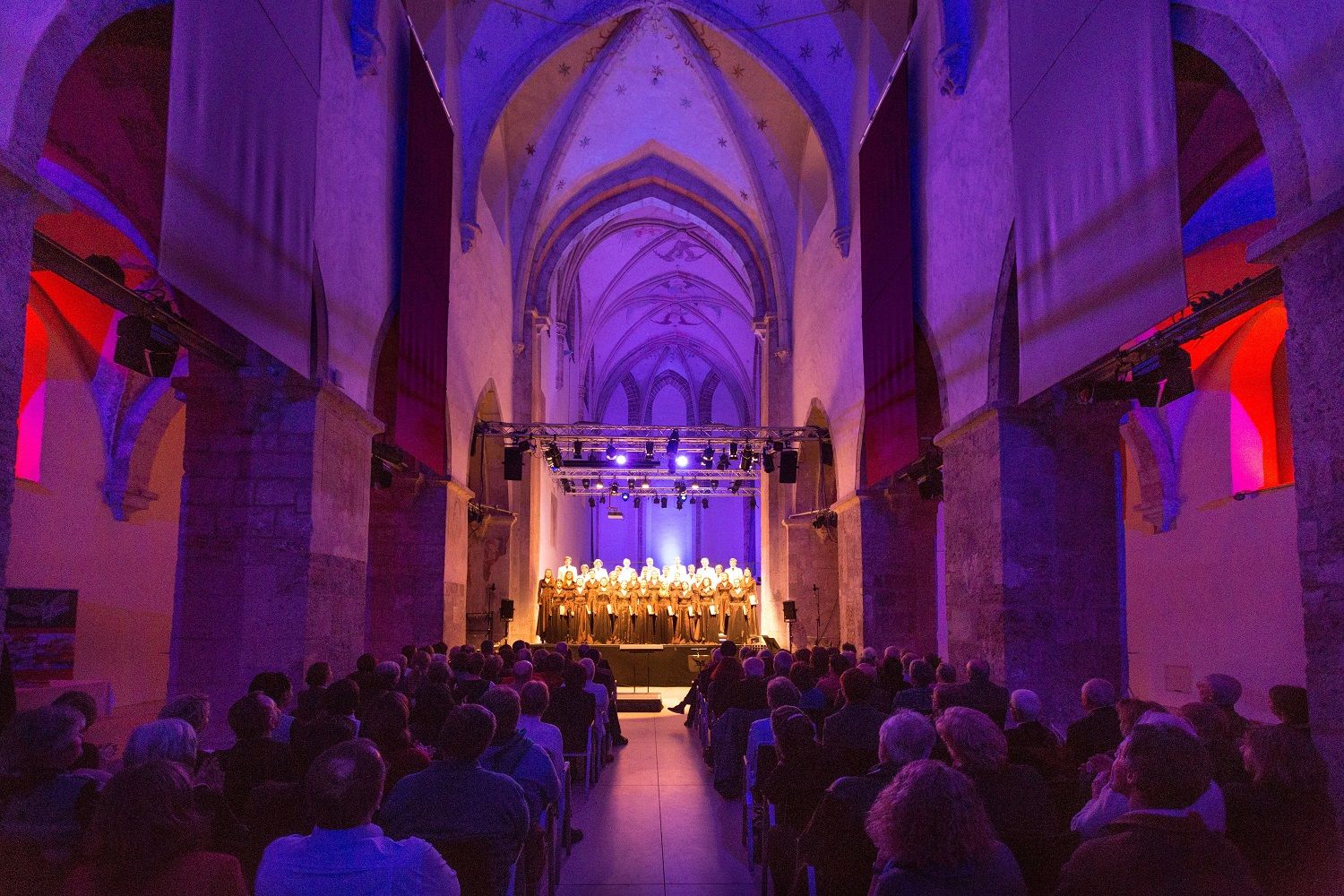 Interior view of the Minorite Church in Krems during a concert with illuminated choir.