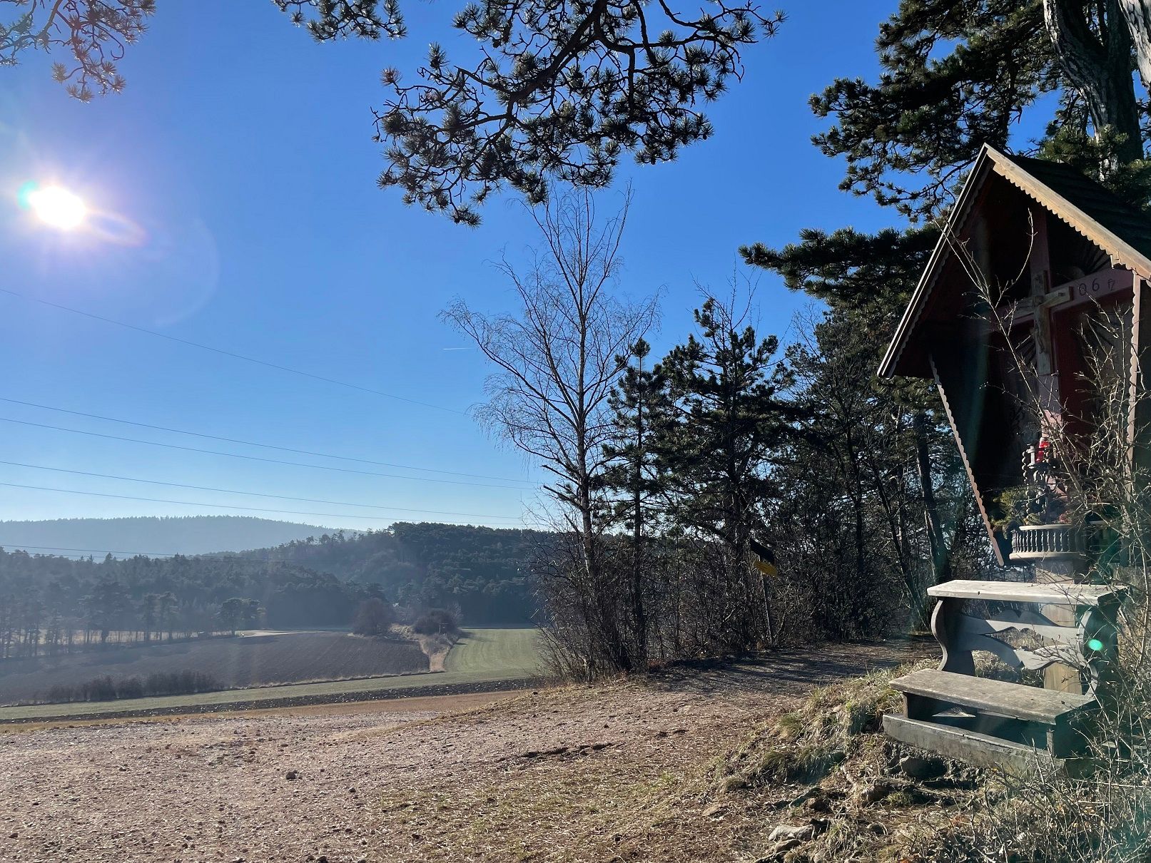 Landscape with huts and trees in the sunshine.