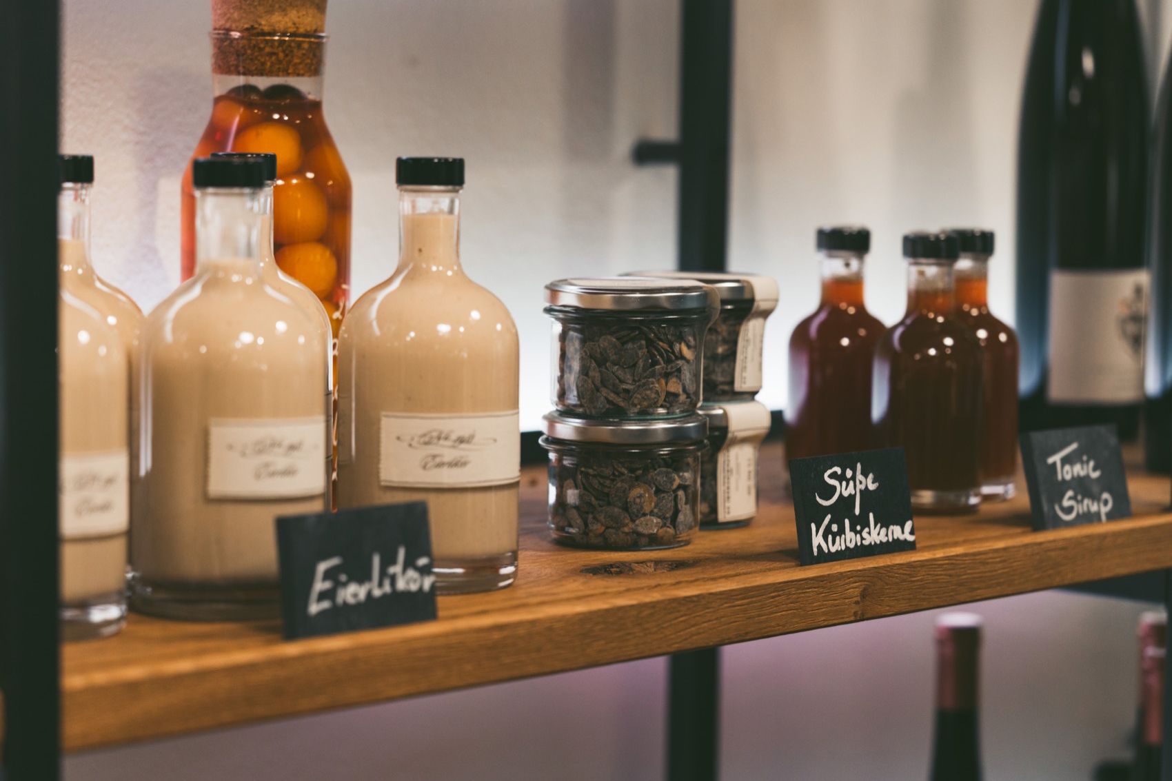 Shelf with bottles and glasses in a store.