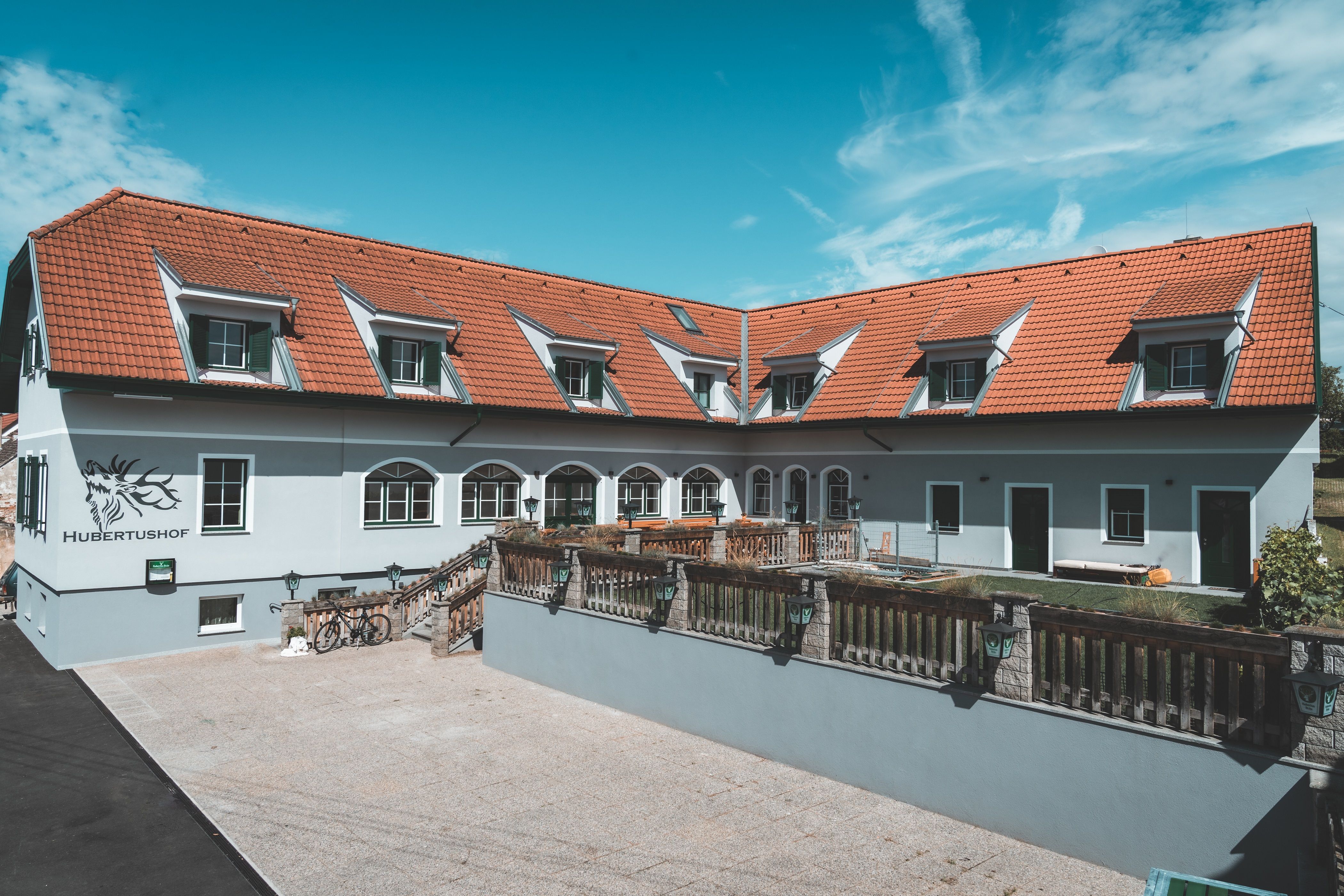 A building with red roof tiles and several skylights, labeled 'Hubertushof'.