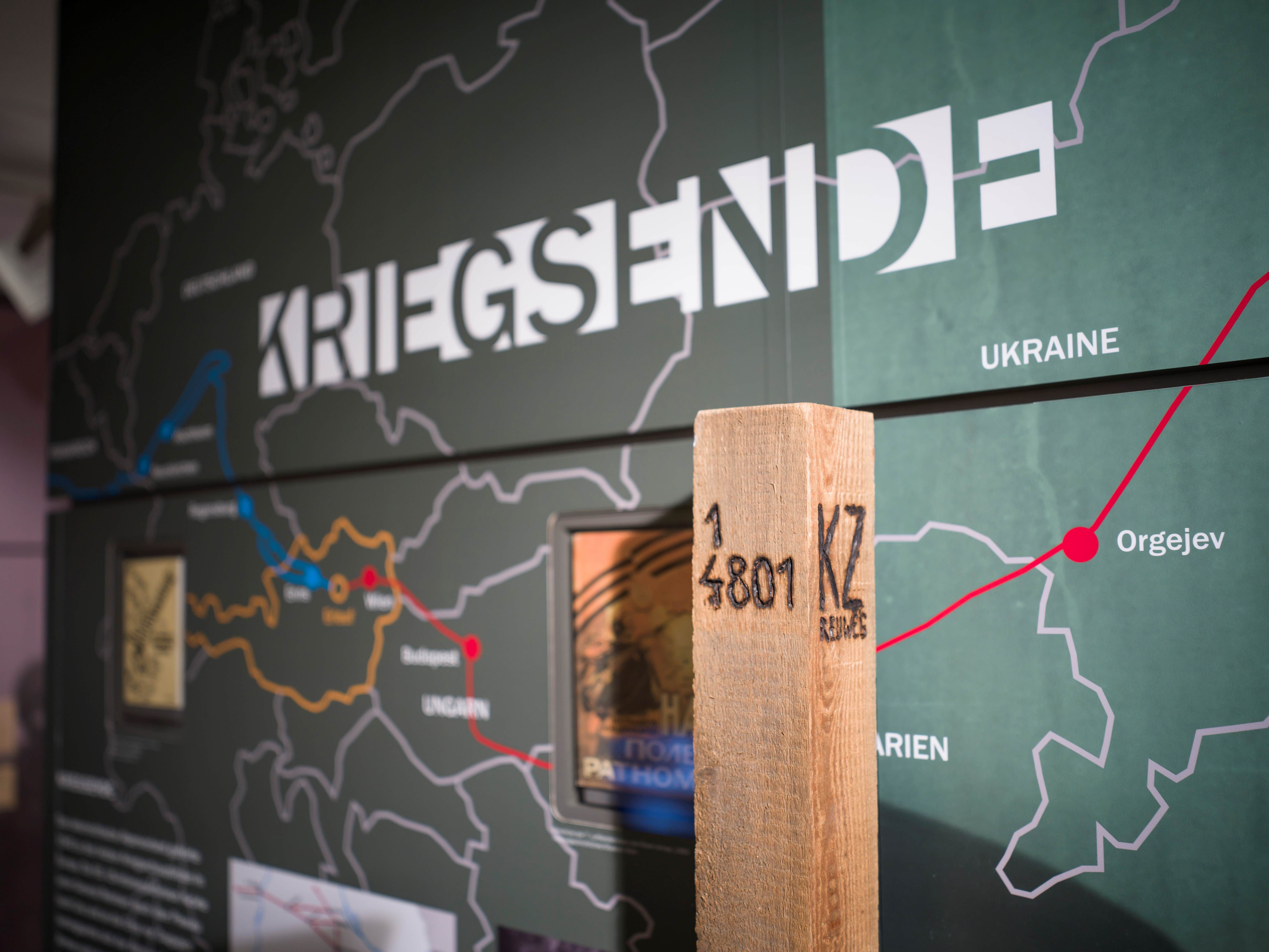 Interior view of the Erlauf Peace Museum with a map and a wooden post.