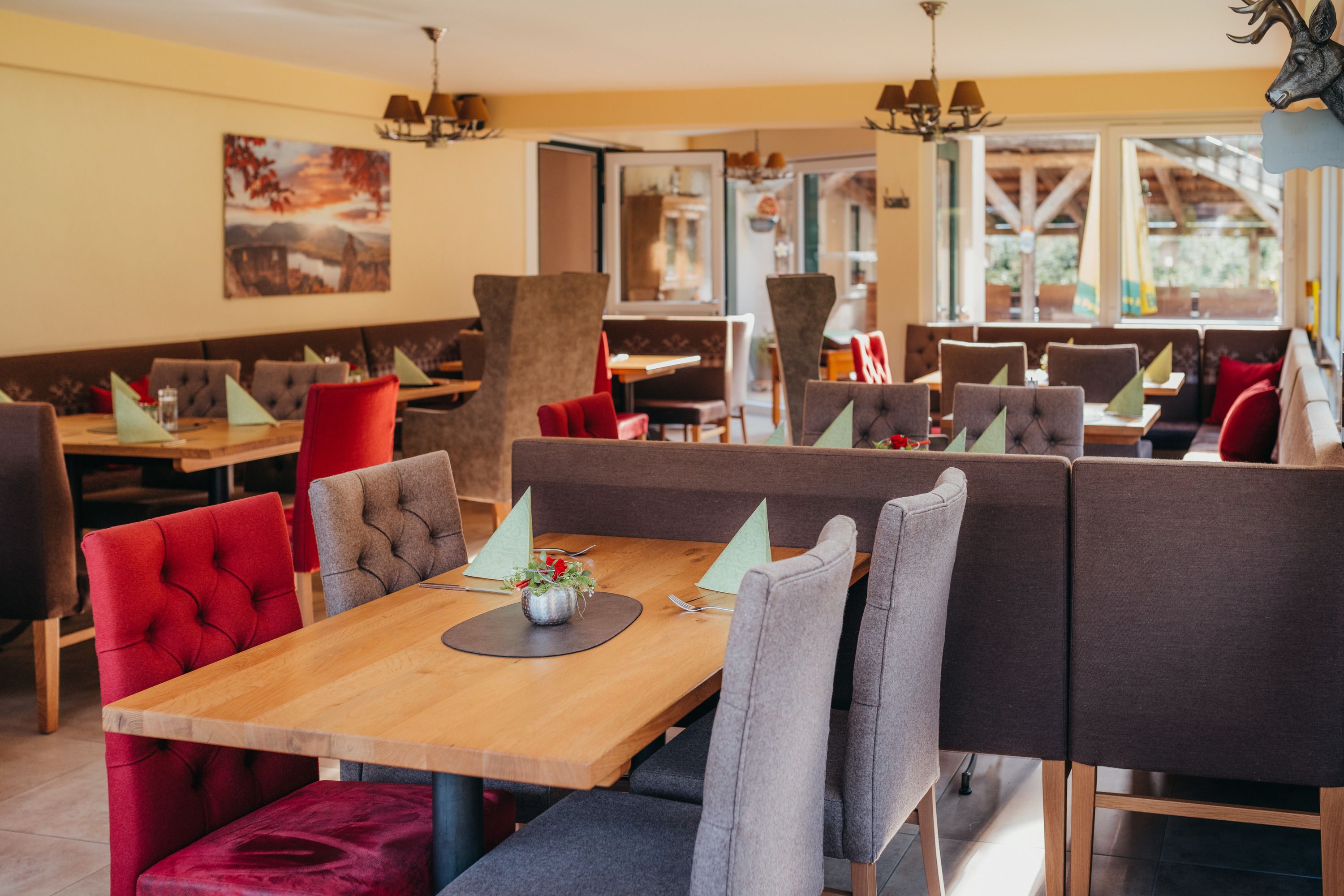 Cozy restaurant with wooden tables and upholstered chairs.