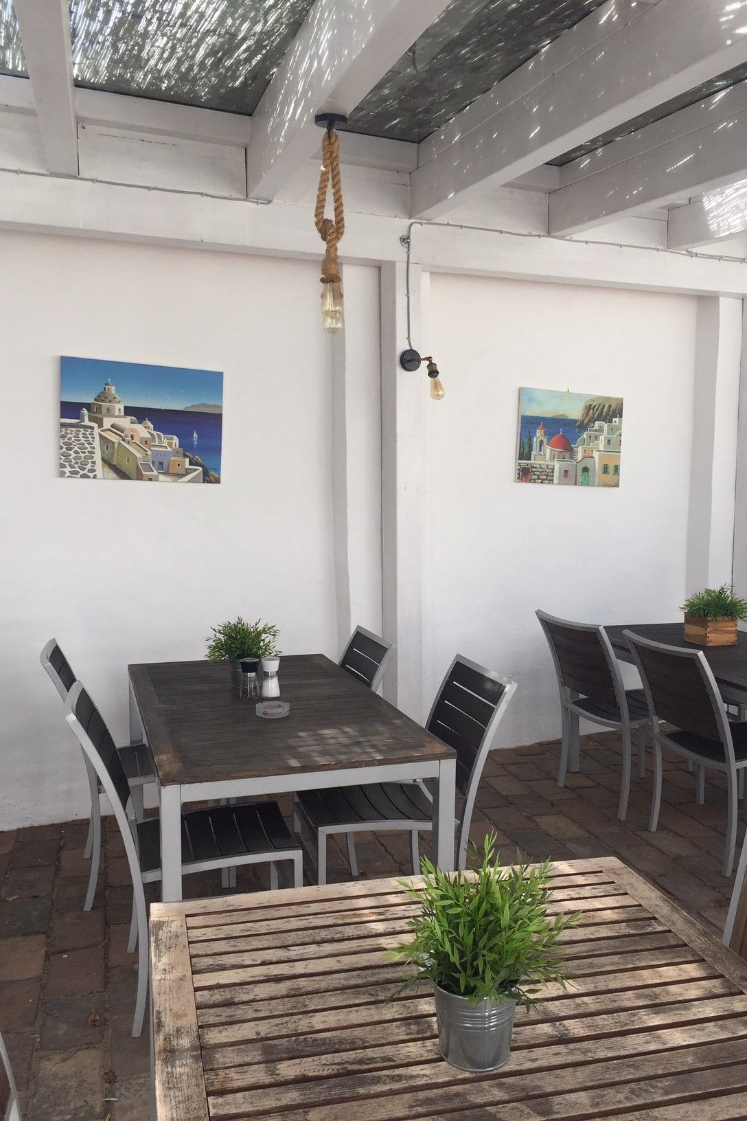 Table in front of white wall in outdoor area 