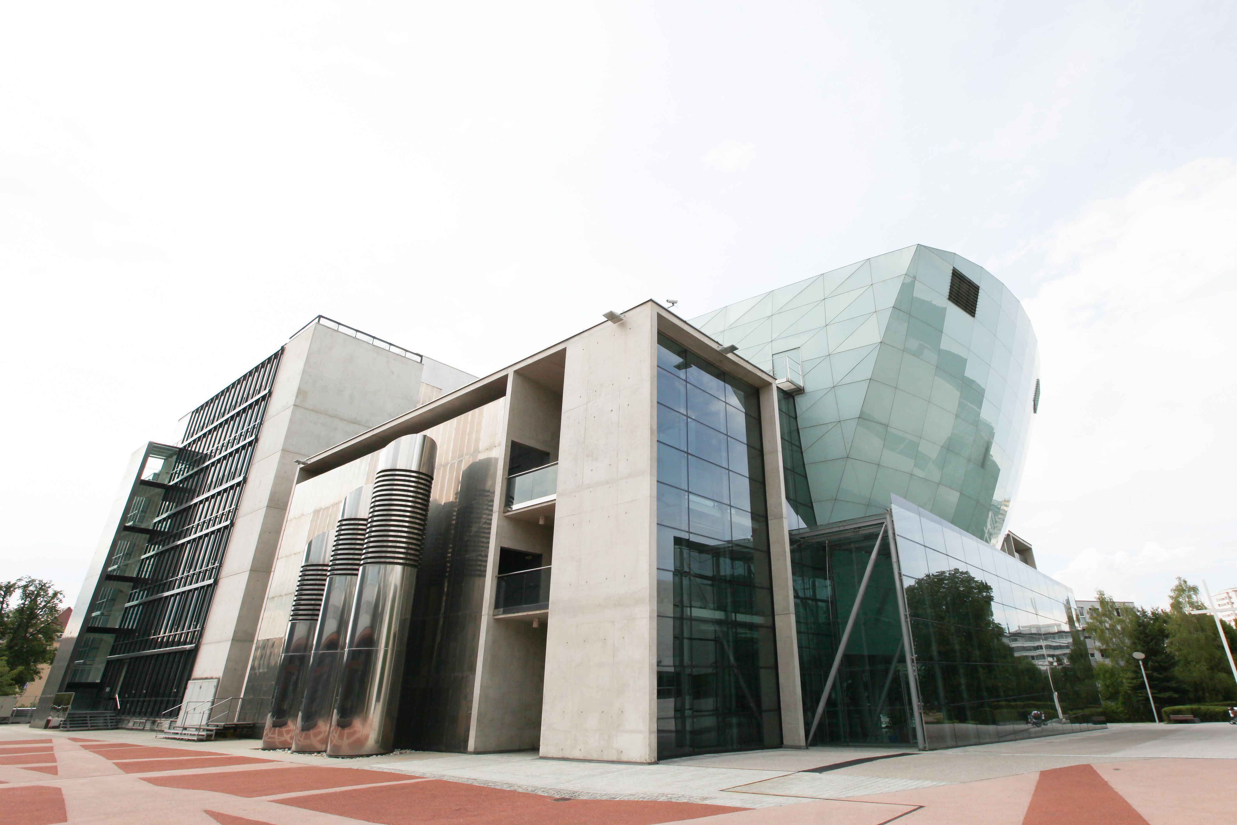 Modern building with glass façade and geometric shapes.