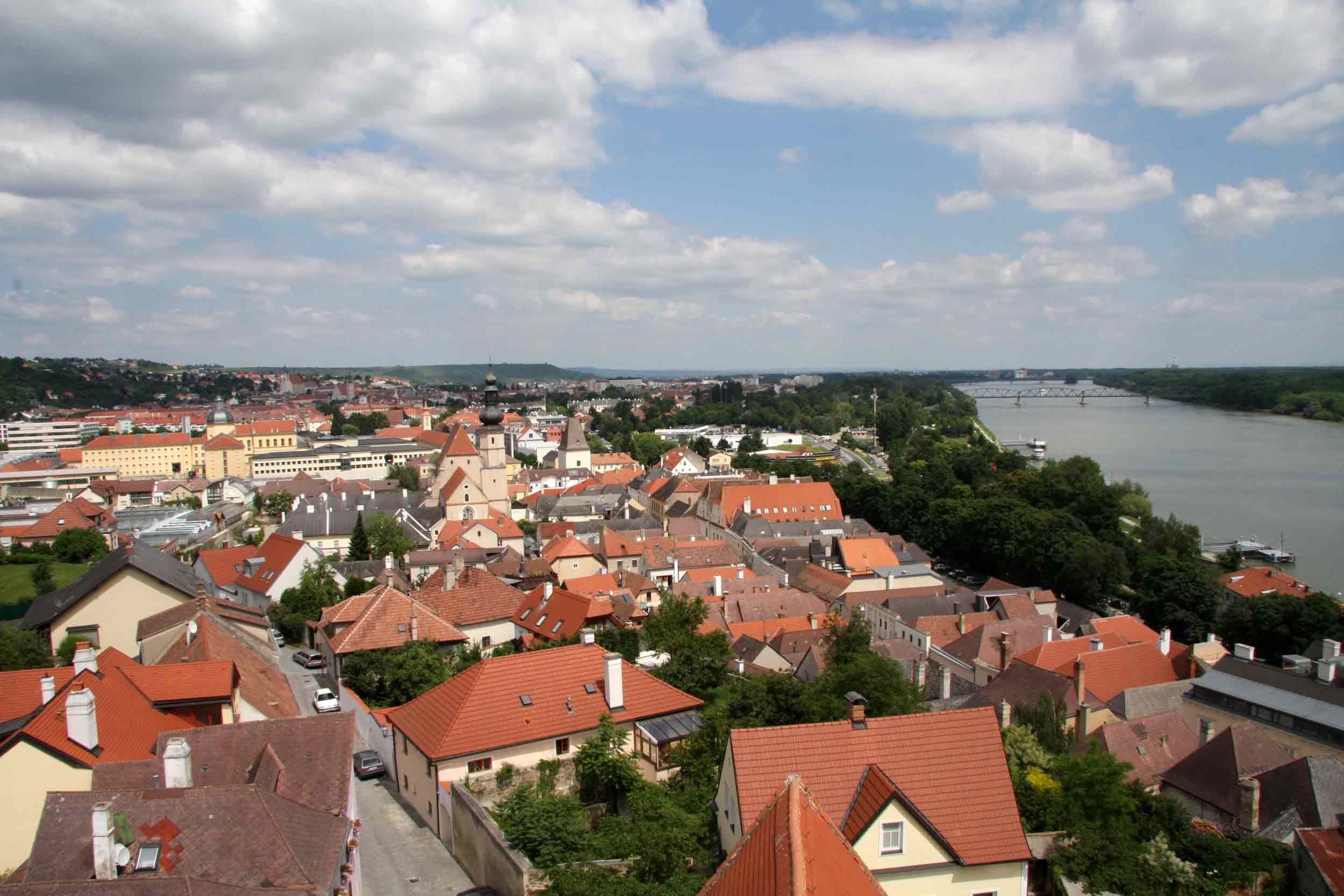 Panoramic view of the rooftops of Krems with the river and bridge in the background.