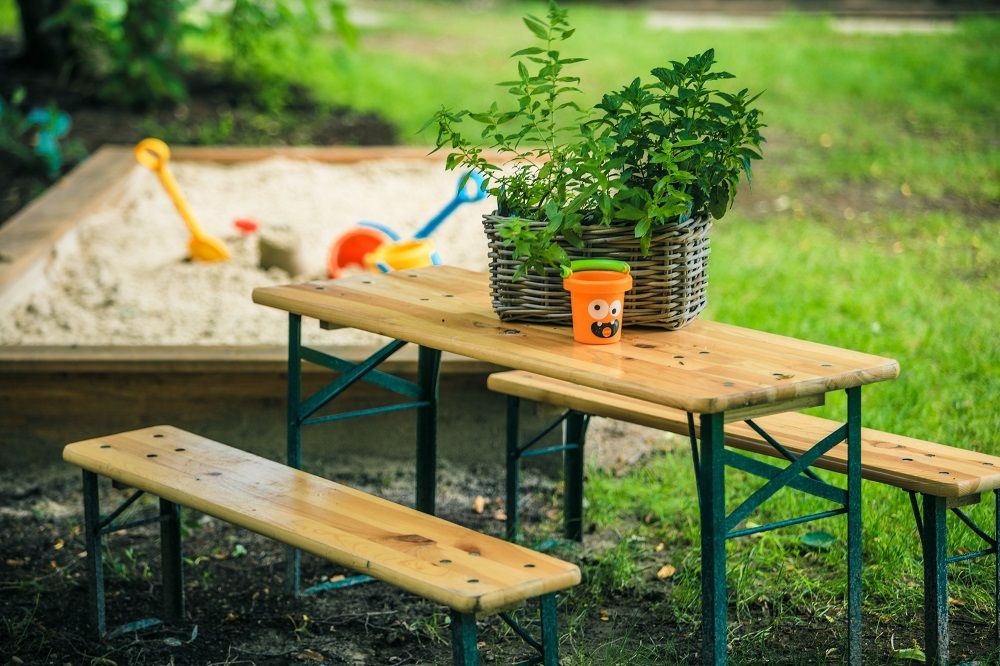 Children's pub set at the sandpit next to a green meadow