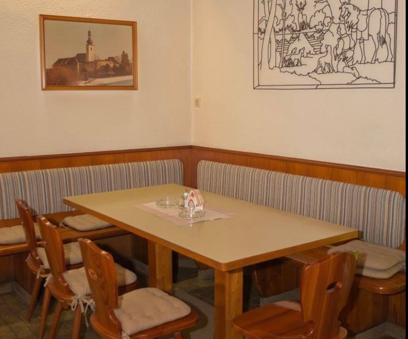 Cozy sitting area in an inn with wooden furniture and wall decorations.