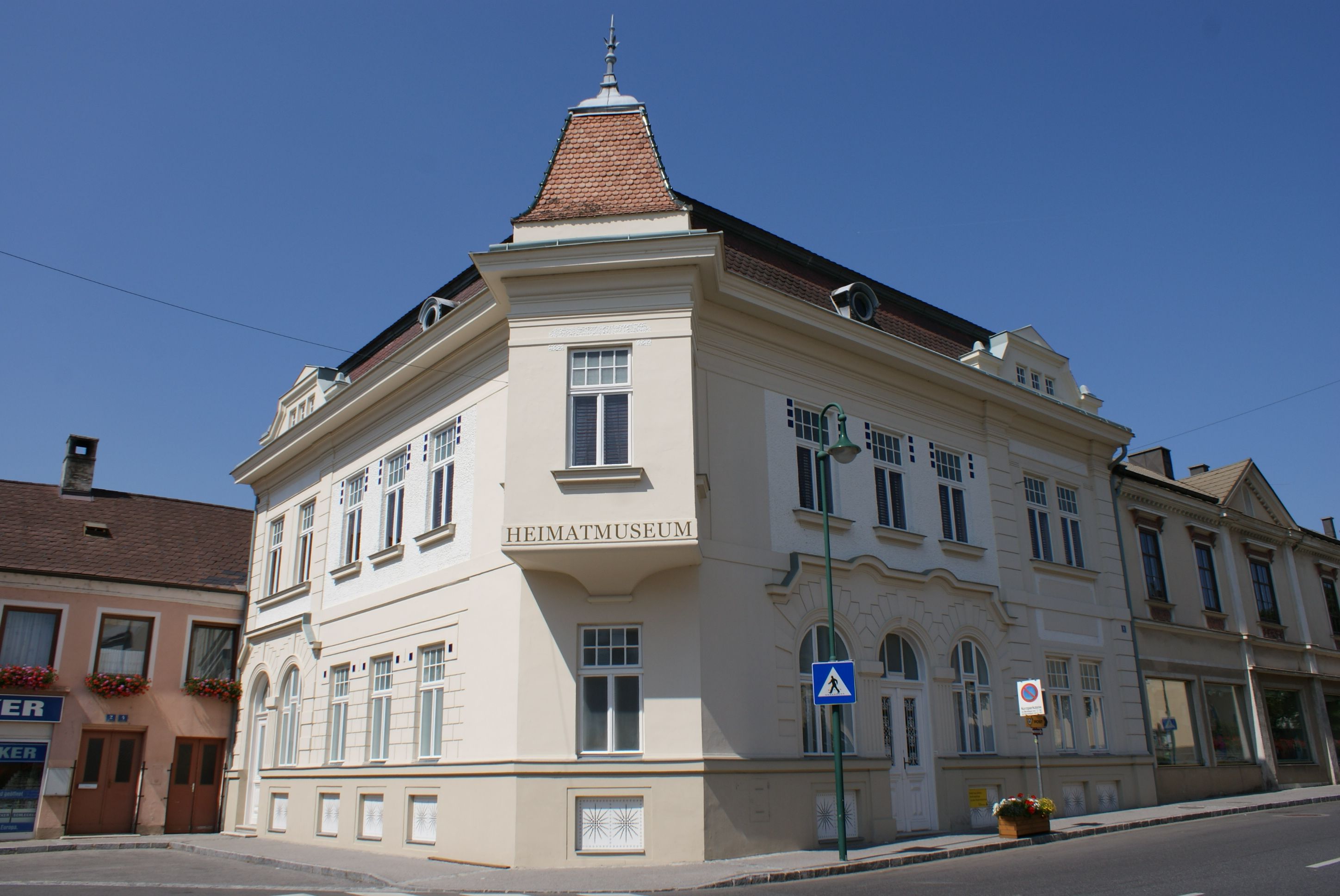 A historic building with the inscription 'Heimatmuseum' in Mank, Austria, under a clear sky.