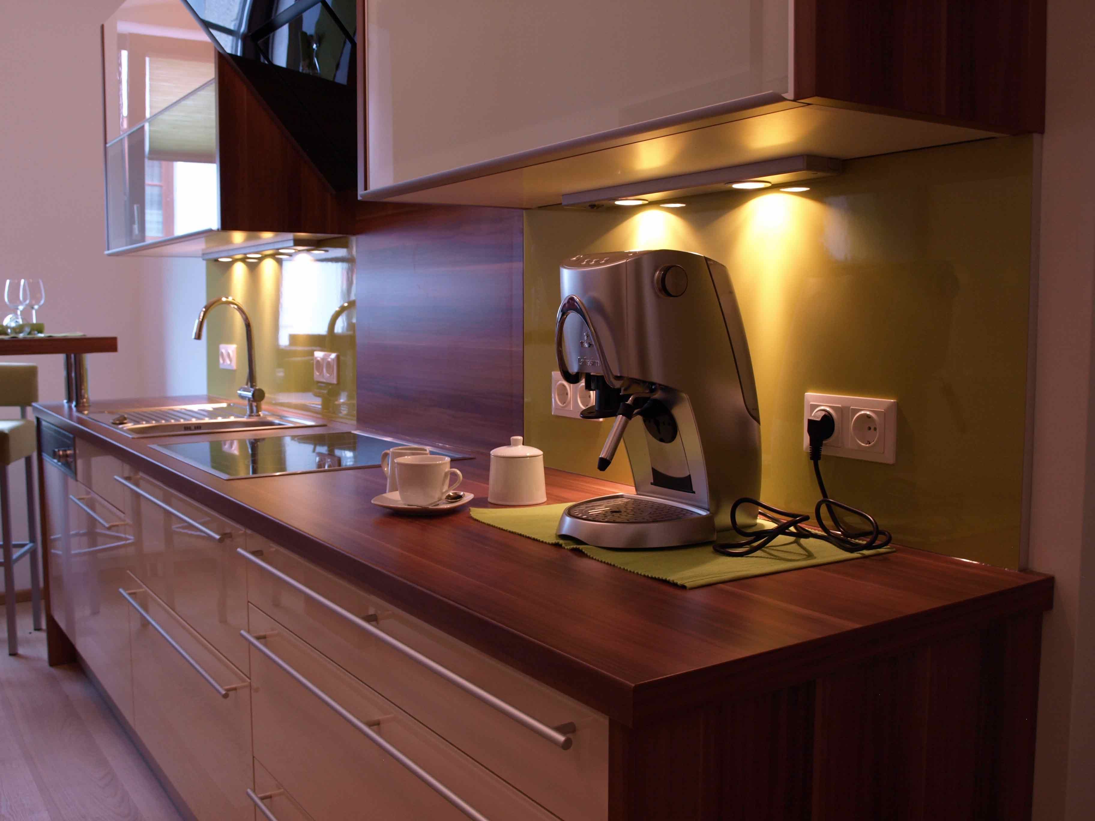 Modern kitchen with coffee machine and sink.