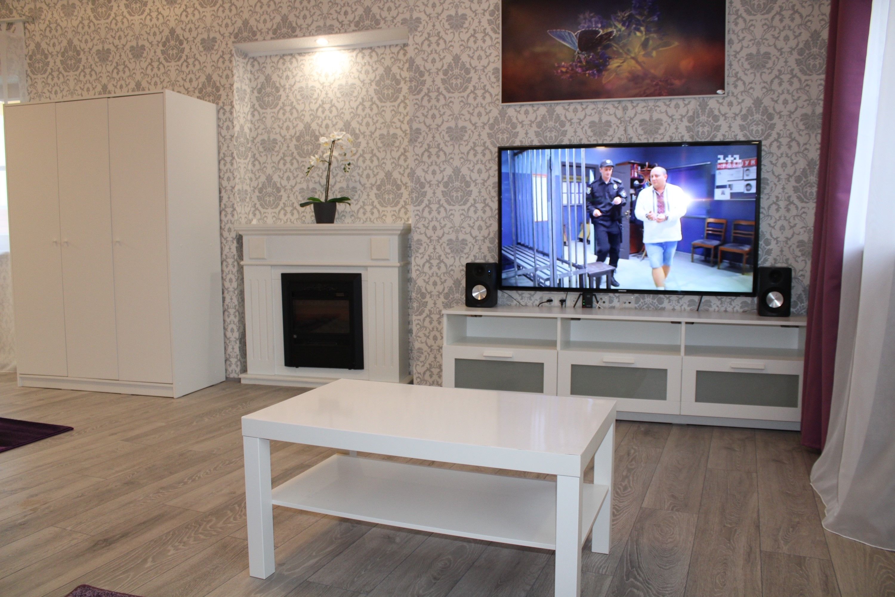 White coffee table in the living room with TV