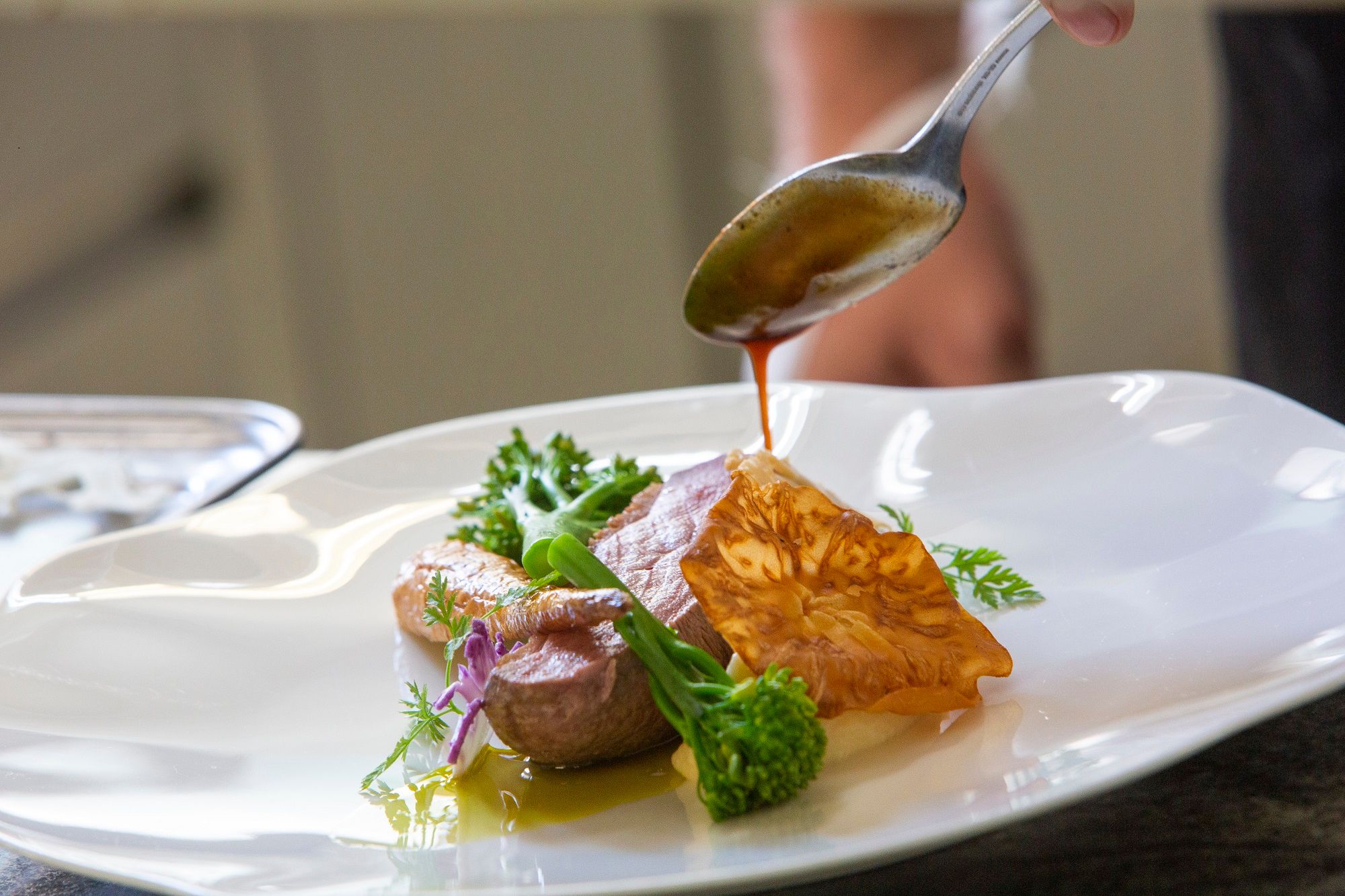 A gourmet dish is refined with a sauce.