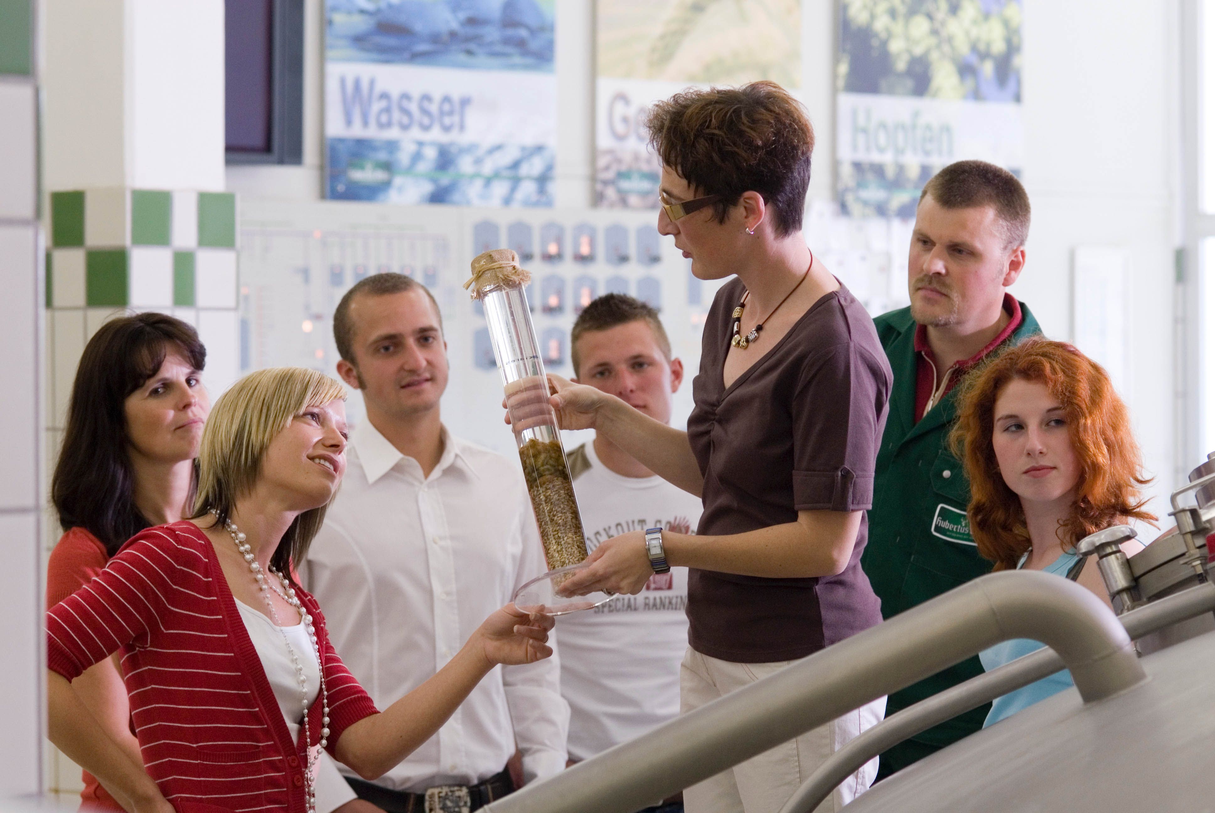 Group of people on a guided tour of a brewery.