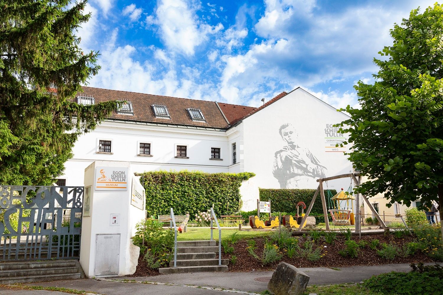 Egon Schiele Museum with playground and mural.