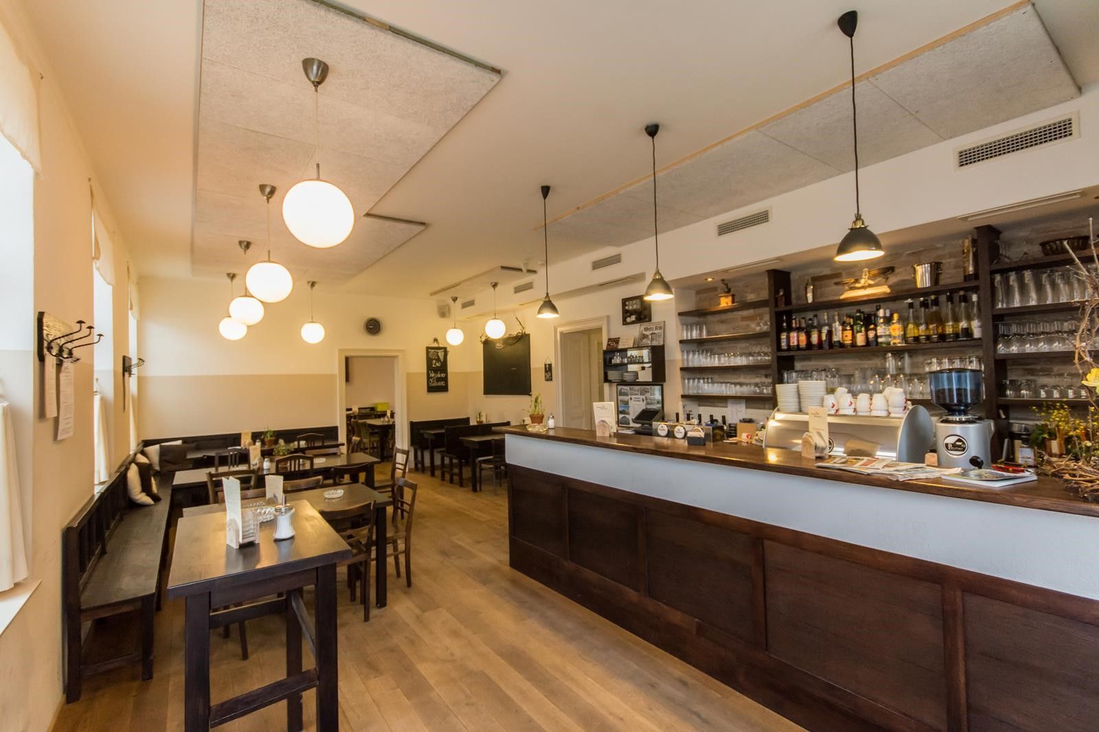 Interior view of a cozy pub with wooden furniture and bar.