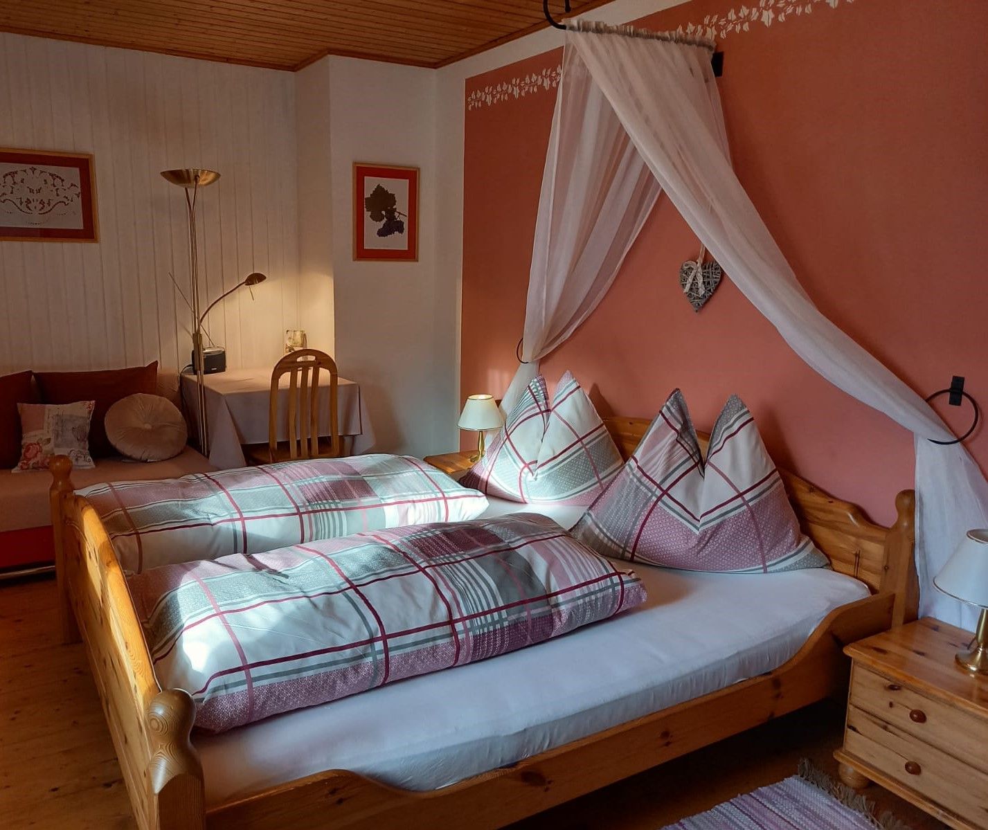 Comfortable guest room with double bed, bedside lamps and desk.