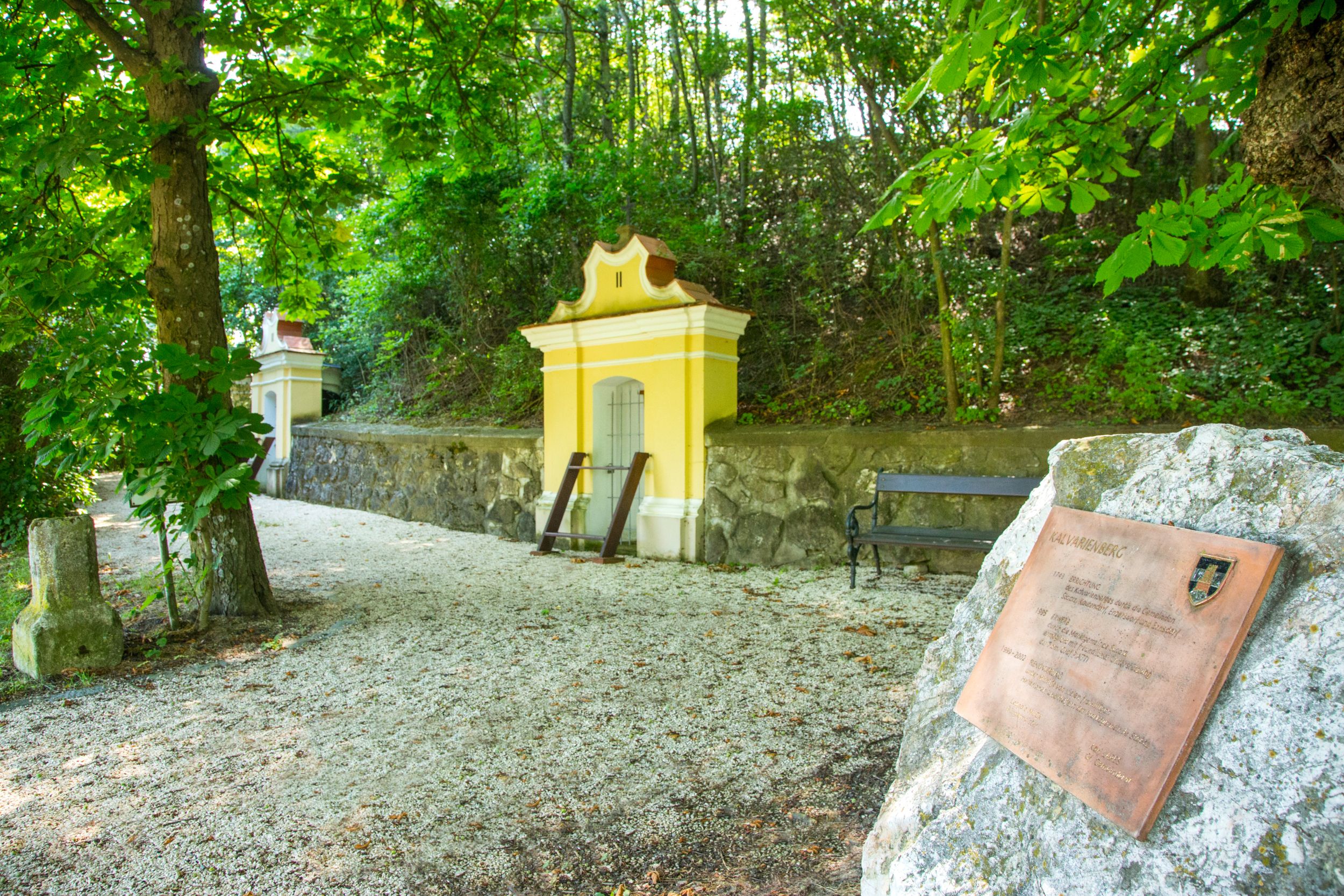 Calvary in Staatz with yellow chapels and memorial plaque.