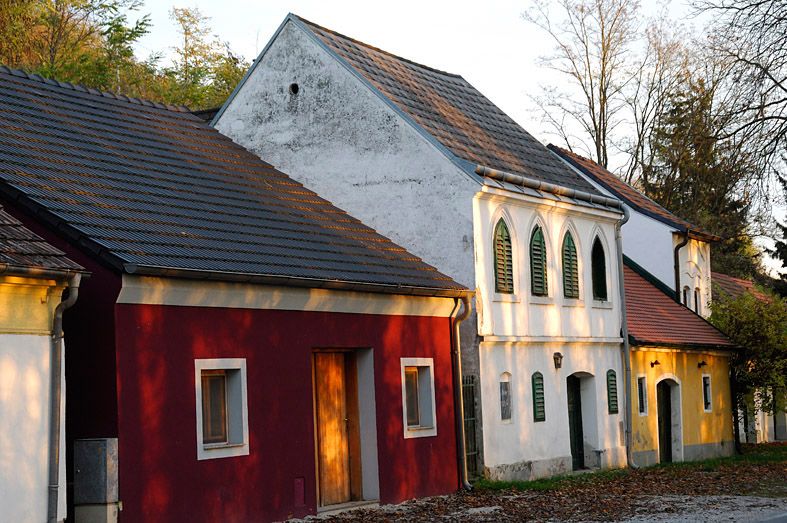 Traditional wine cellars in the Absberg wine cellar lane with colorful facades and green shutters.