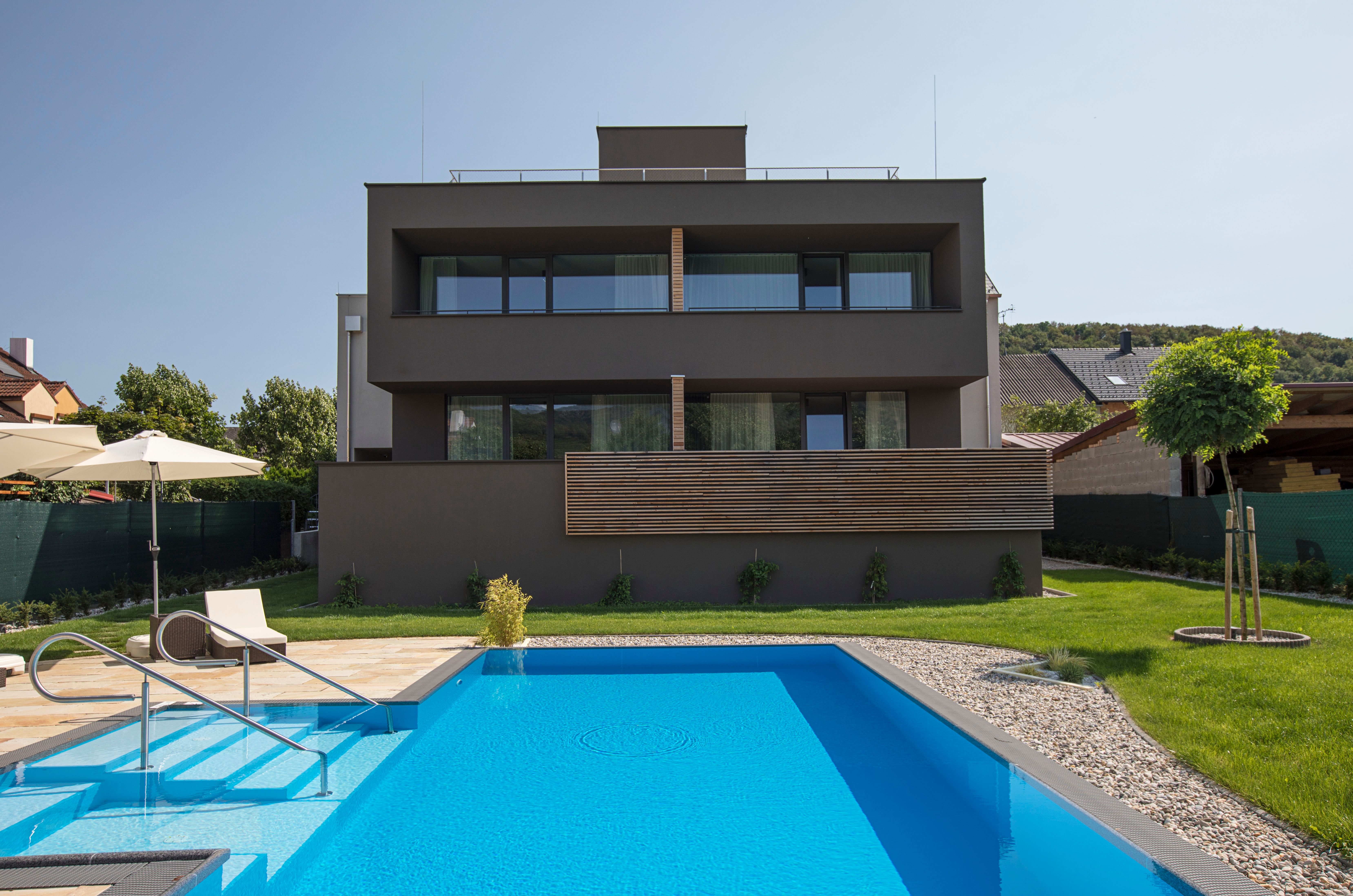 Rear view of a modern building with pool and garden.