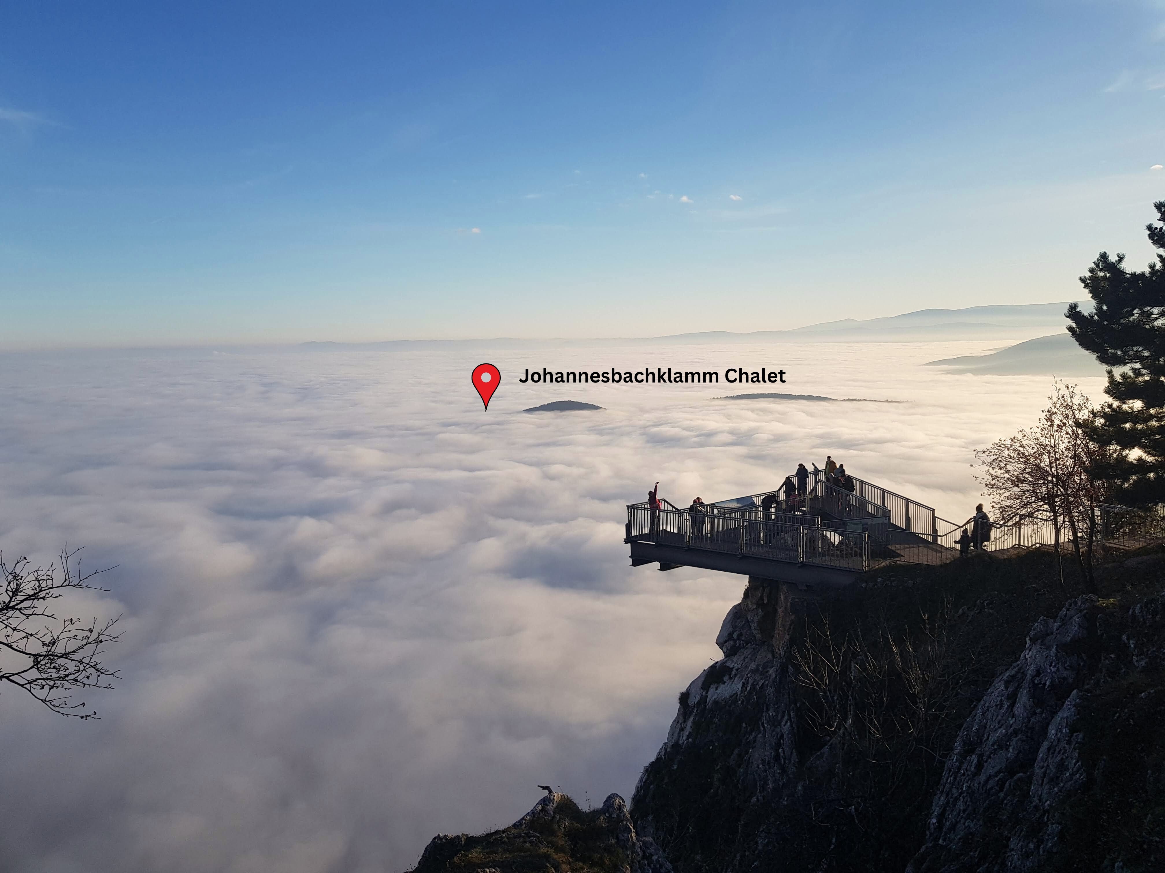 Skywalk Hohe Wand above a cloud cover with a view of the Johannesbachklamm Chalet.