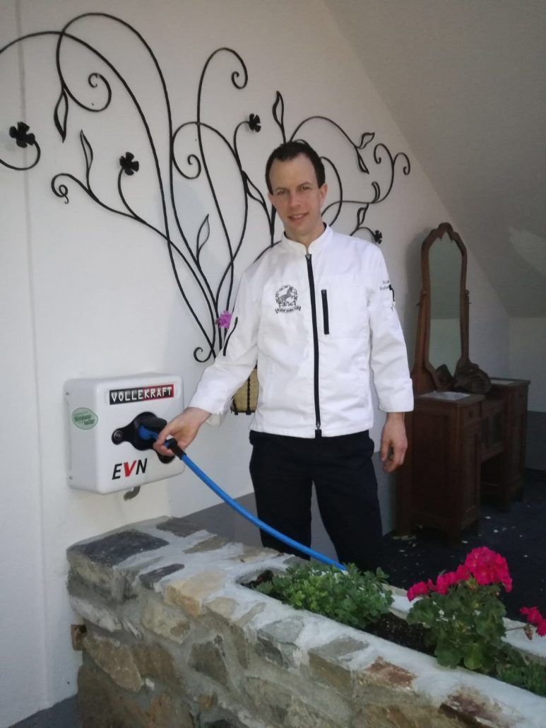 Roman Siebenhandl stands next to the e-charging stations 