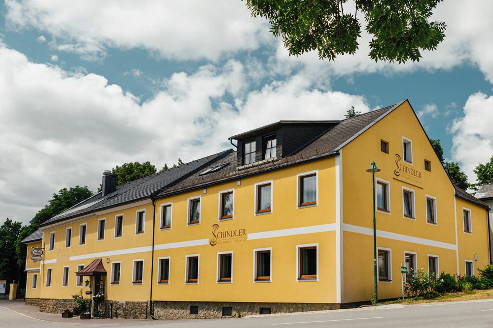 Yellow pub with the inscription 'Schindler' in Brunn am Wald.