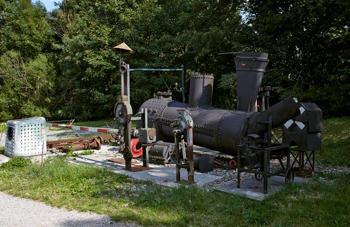 Outdoor exhibition of old cogwheel train parts.