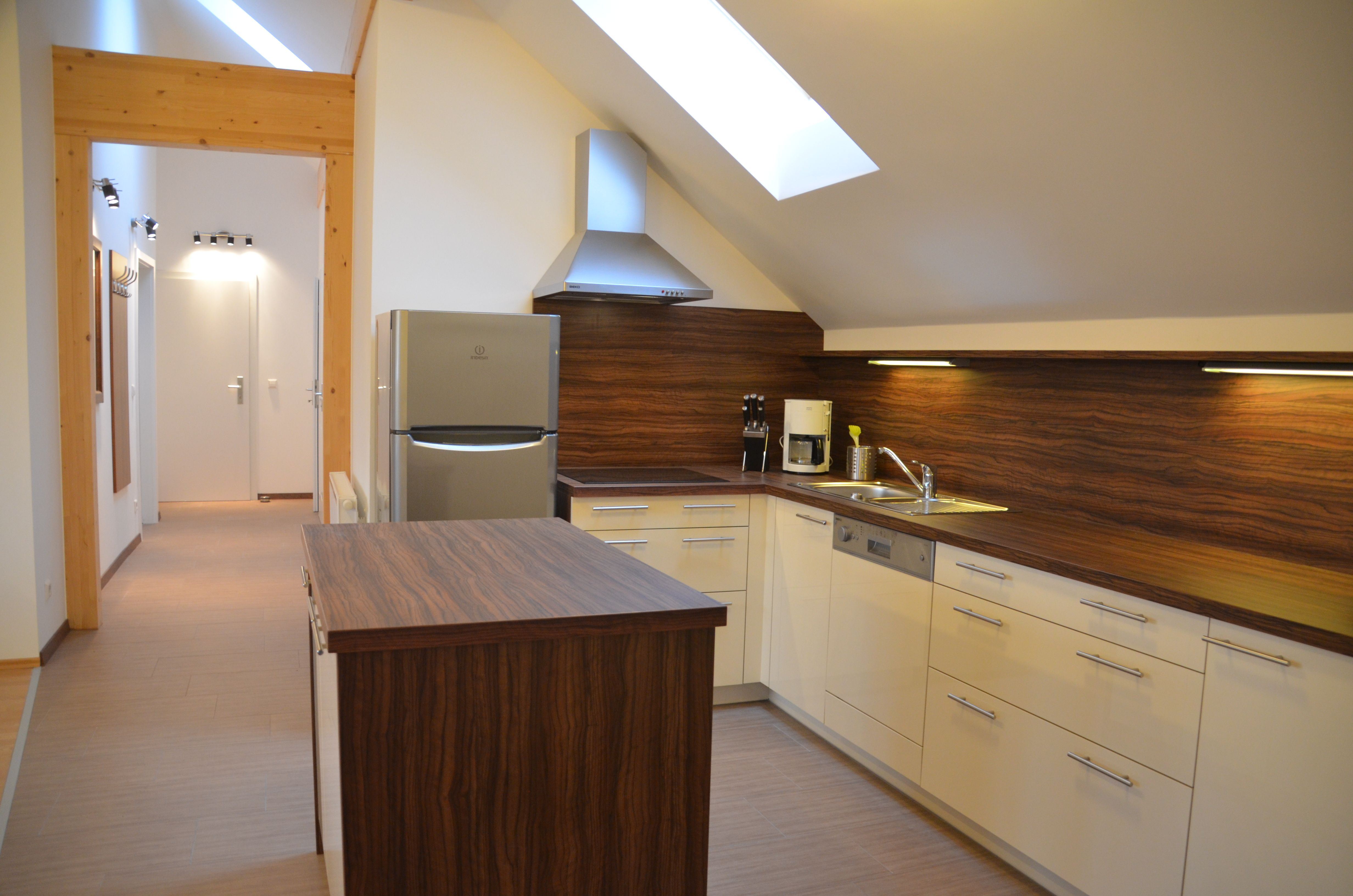Modern kitchen with wooden worktops, skylight and appliances.