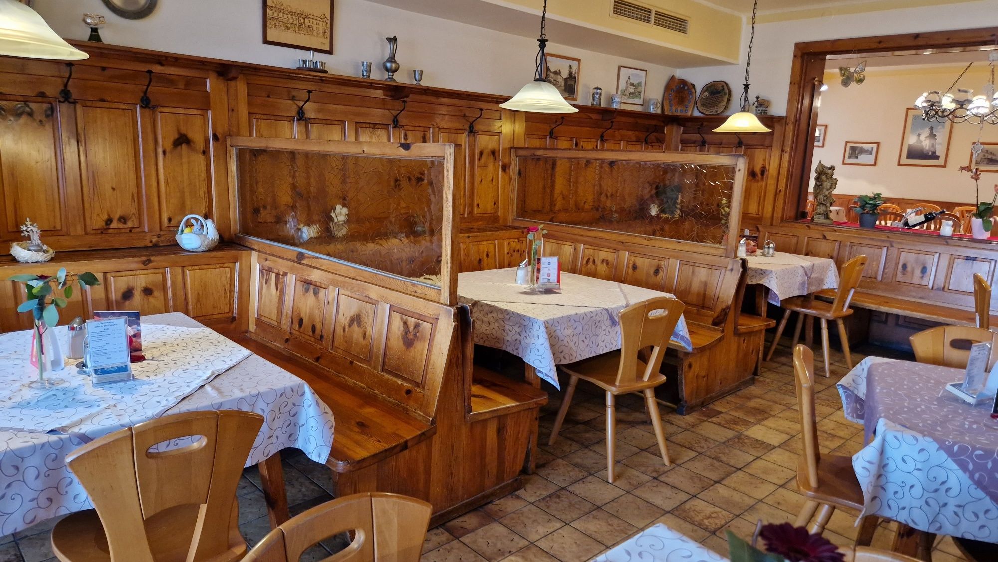 Cozy guest room with wooden furniture and decorated tables.