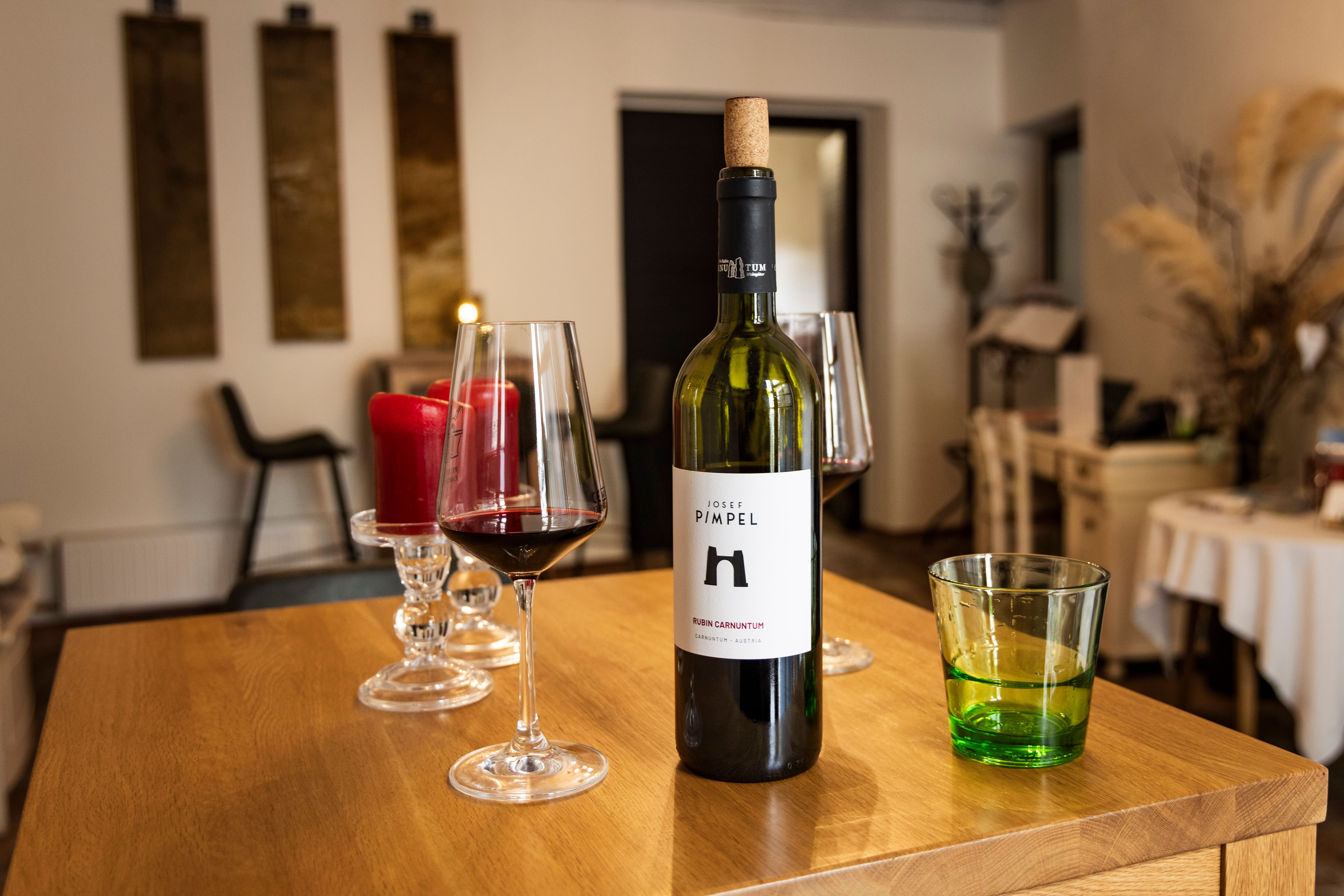 Wine glasses with red wine and wine bottle in the tasting room of the winery