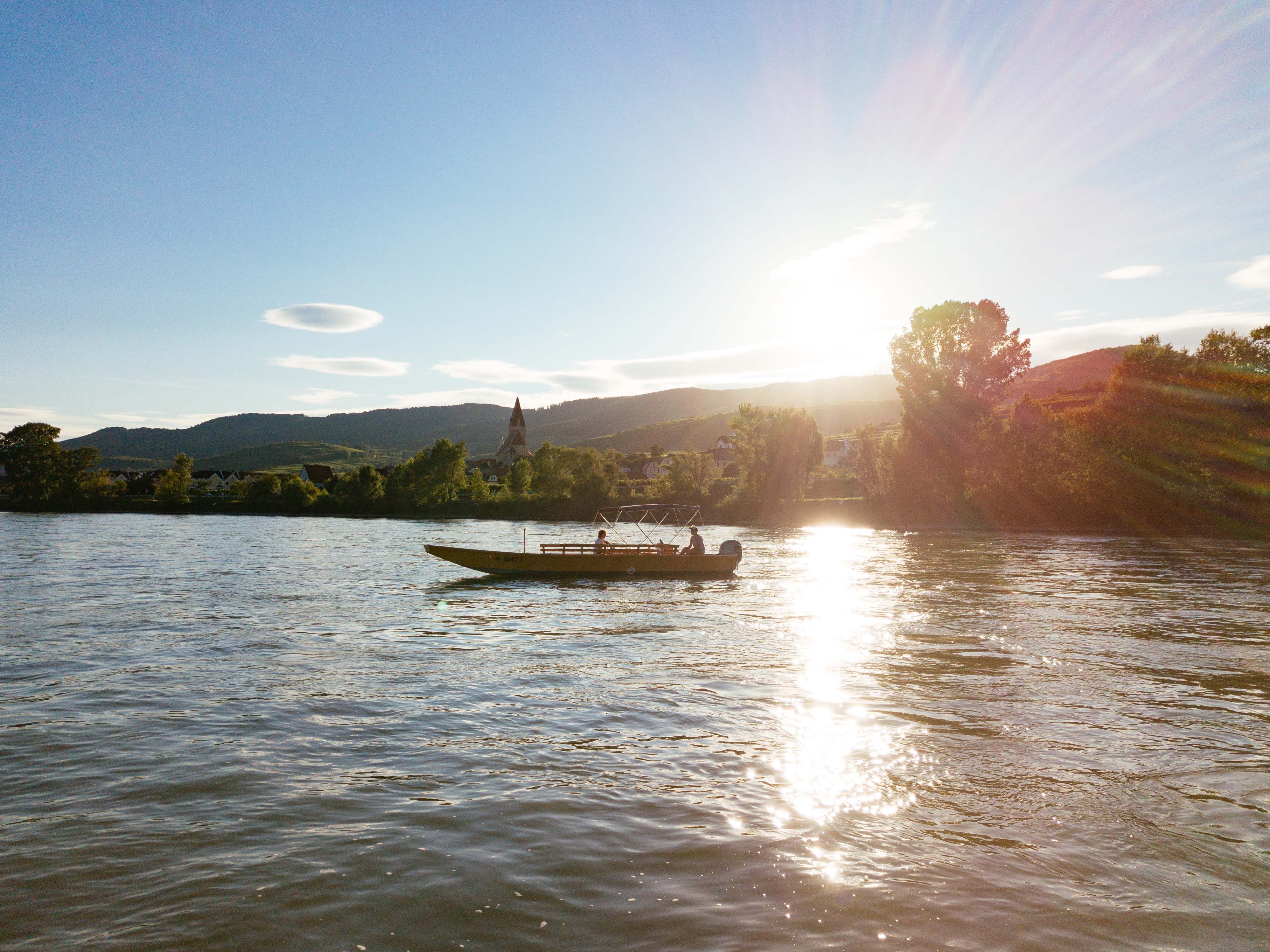 Boat on a river at sunset in the Wachau.