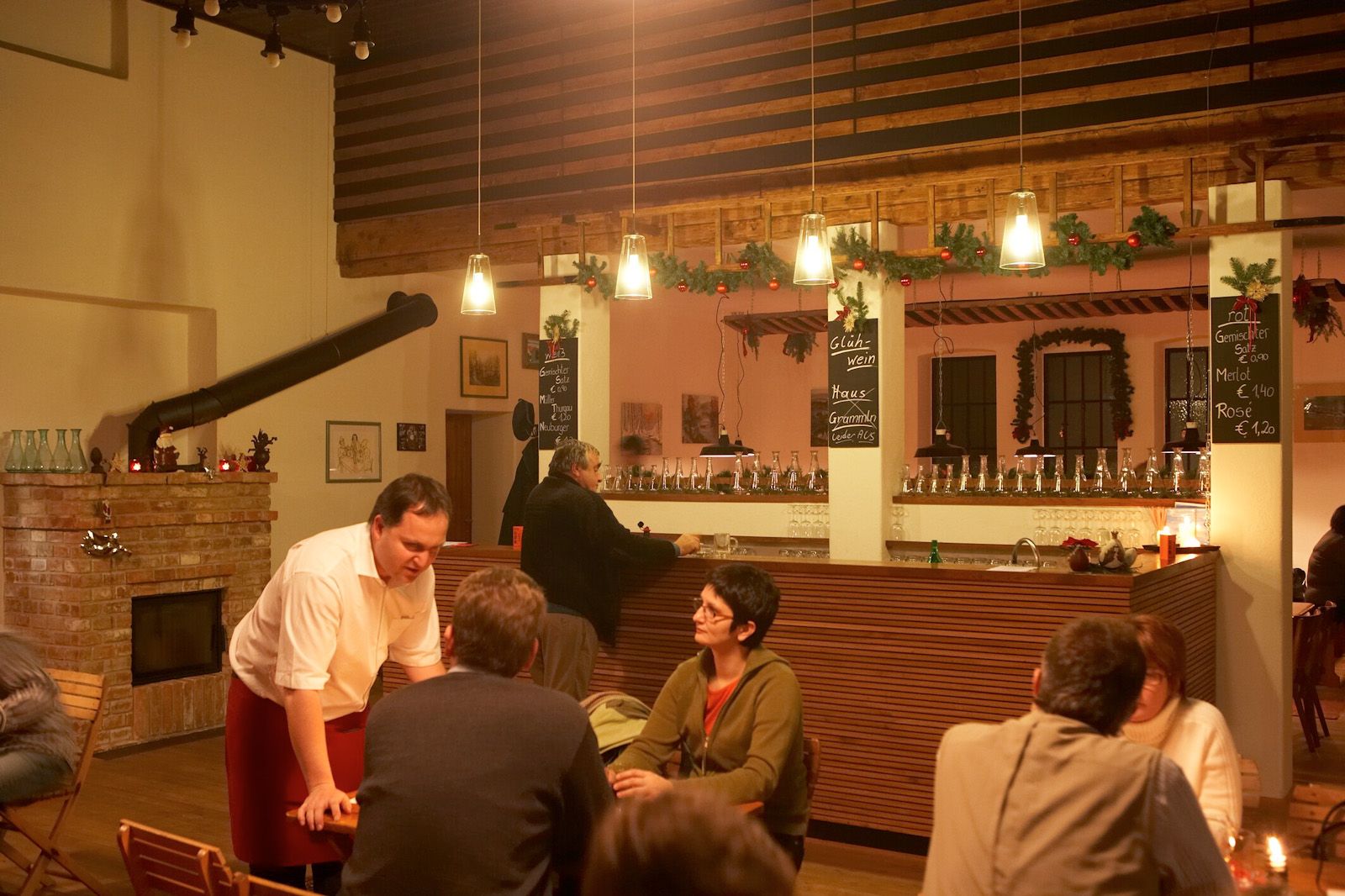 Interior view of a cozy pub with bar and guests.