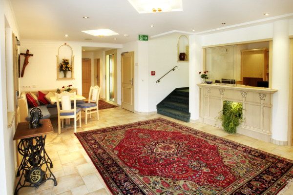 Elegant reception area with carpet, reception desk and seating area.