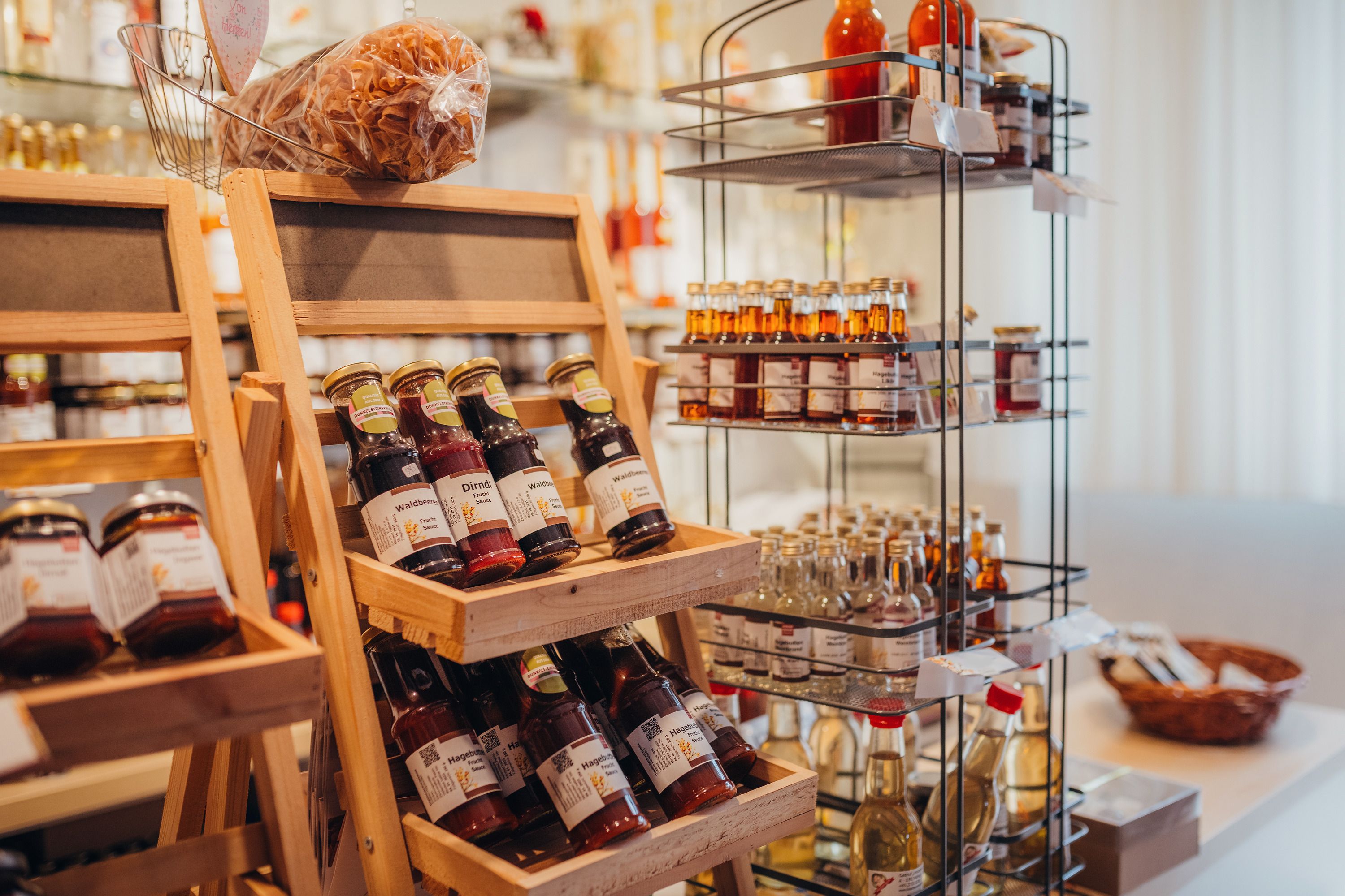Shelves with jams and syrup bottles in a store.